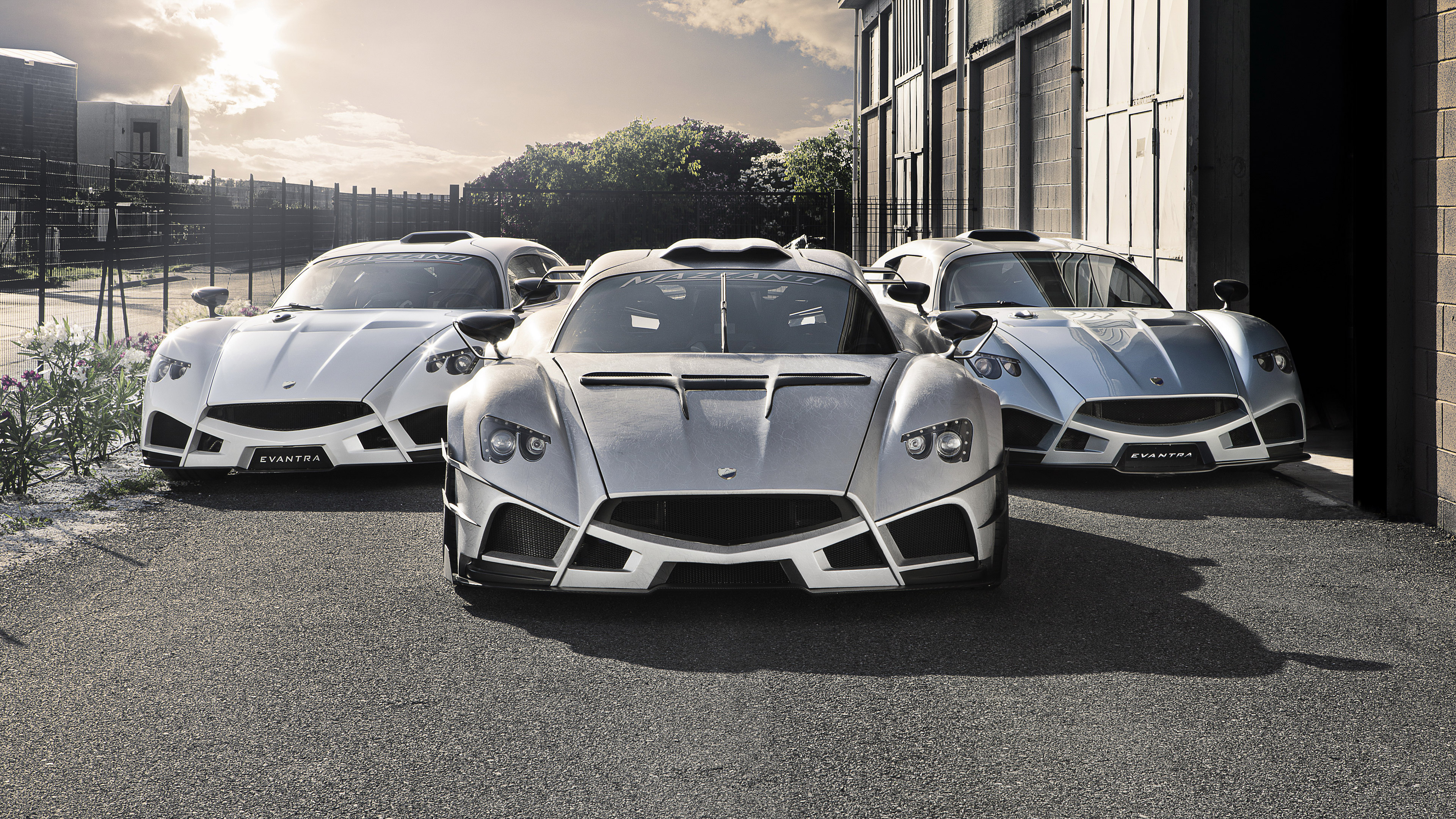 Three Mazzanti Evantra sports cars parked outside HD Wallpaper