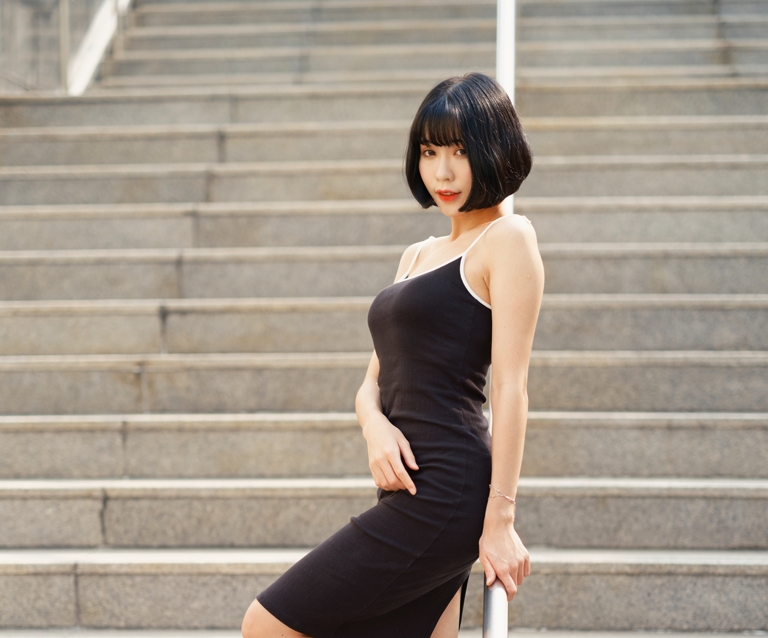 Woman with short black hair in a black dress HD Wallpaper