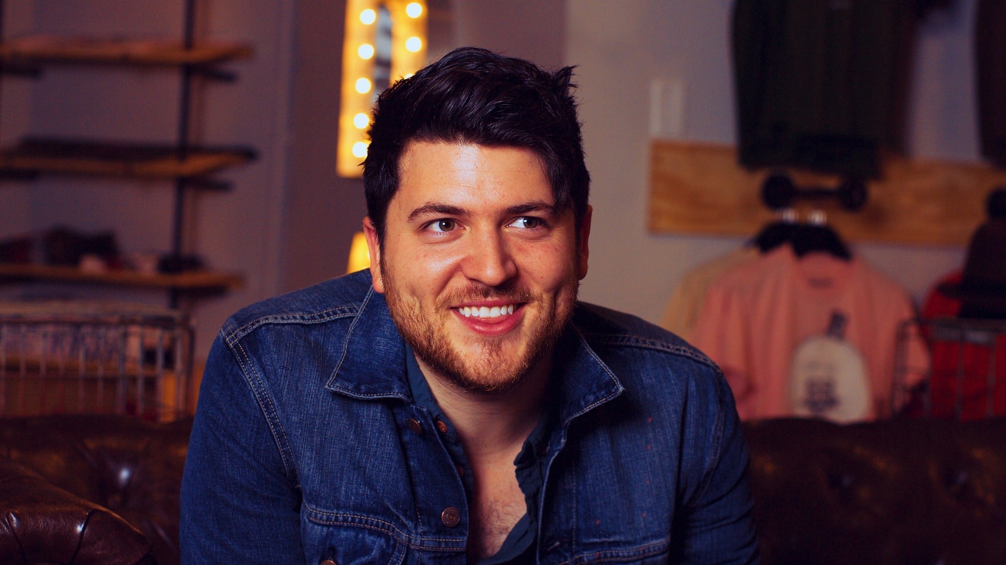 Olan Rogers smiling in a denim jacket HD Wallpaper