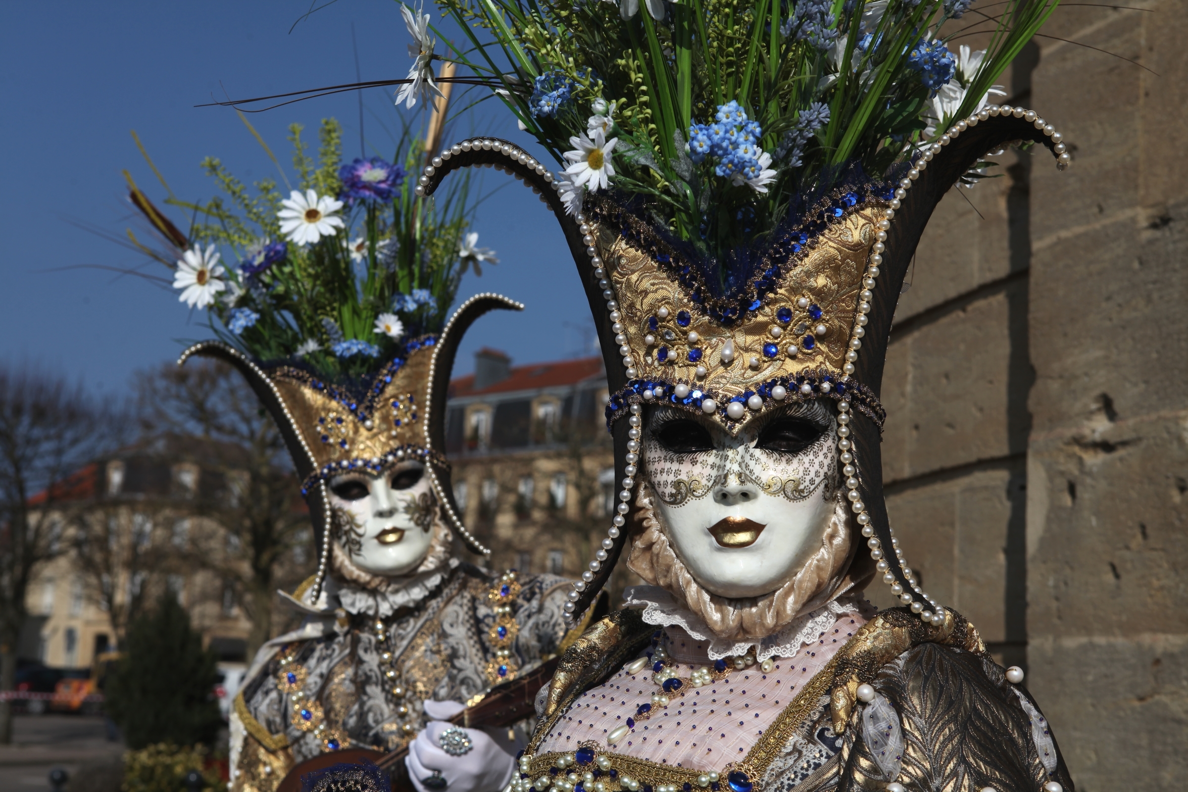 Two people in Venetian carnival costumes with masks and floral headdresses HD Wallpaper