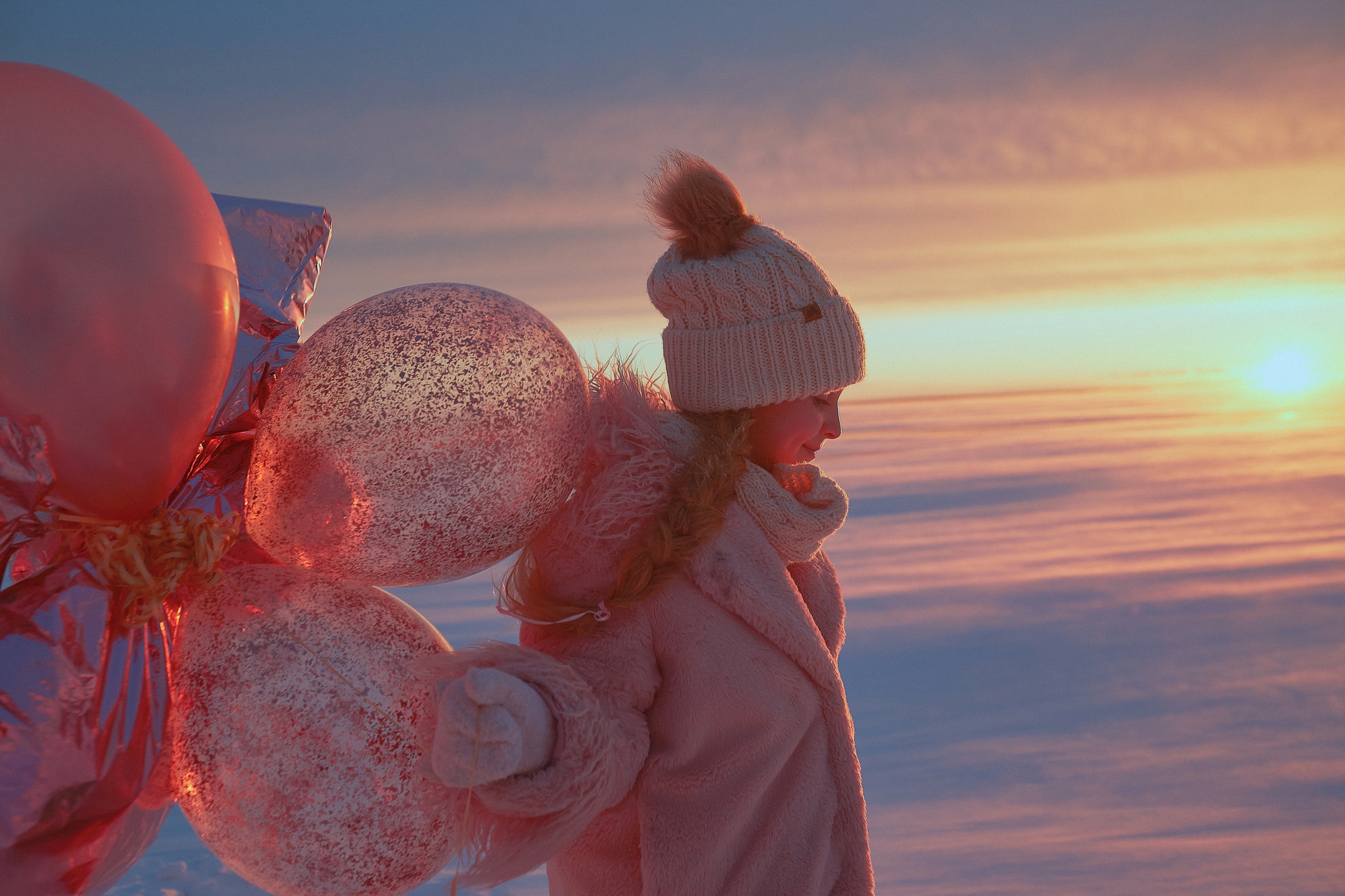 Girl with balloons in winter sunset HD Wallpaper