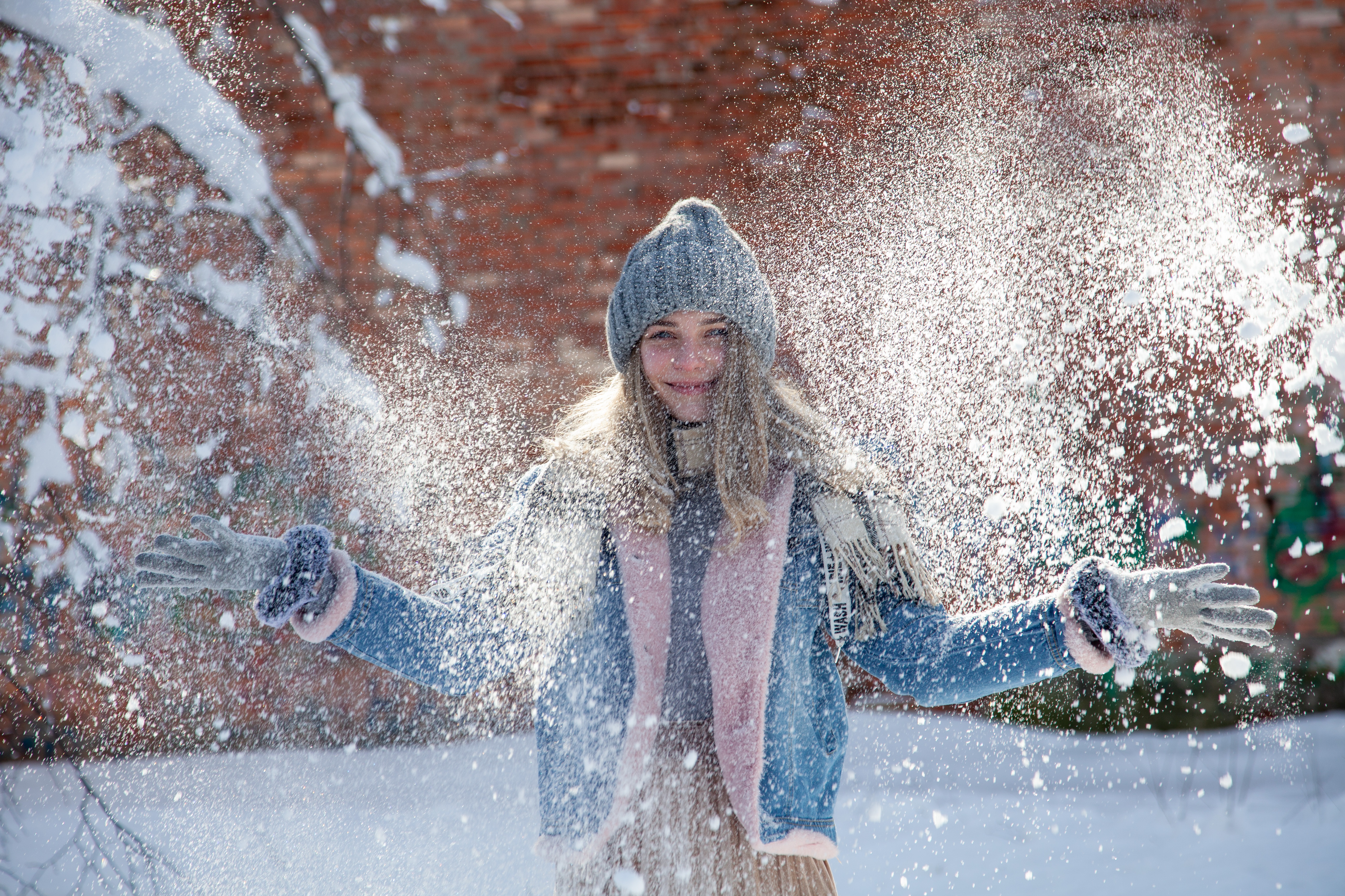 Woman in Winter Hat Throwing Snow HD Wallpaper