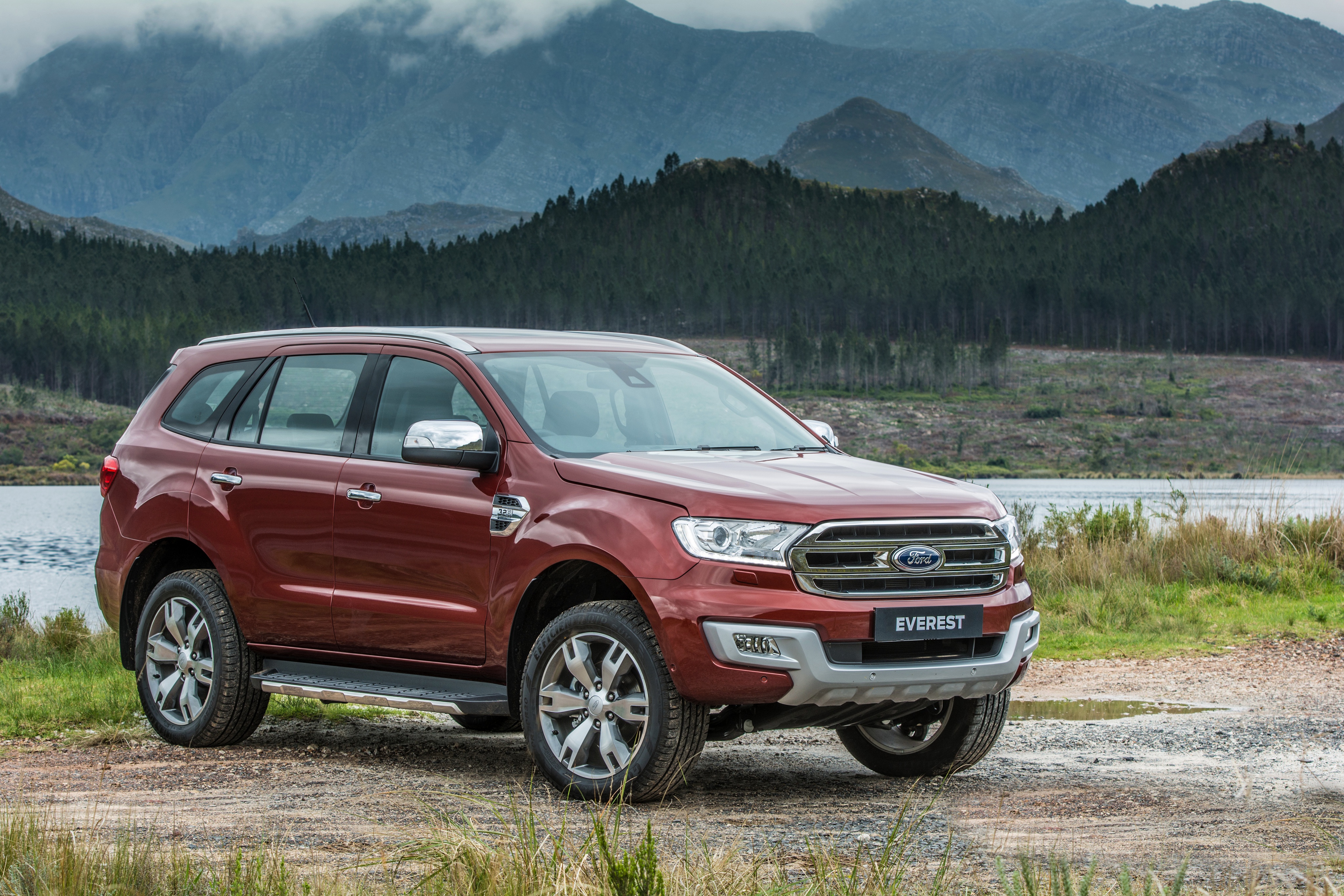 Red Ford Everest SUV parked near a lake and mountains HD Wallpaper