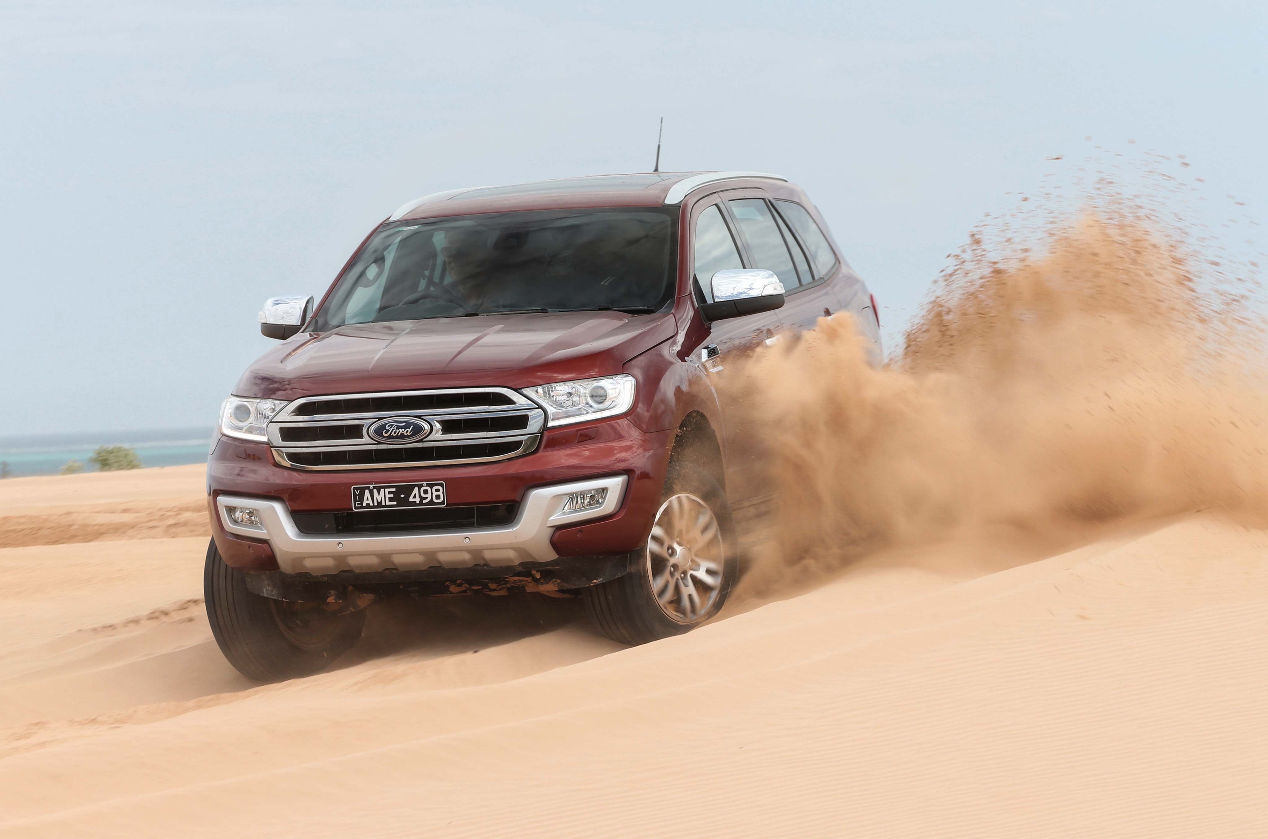 Red Ford Everest SUV driving through sand dunes HD Wallpaper