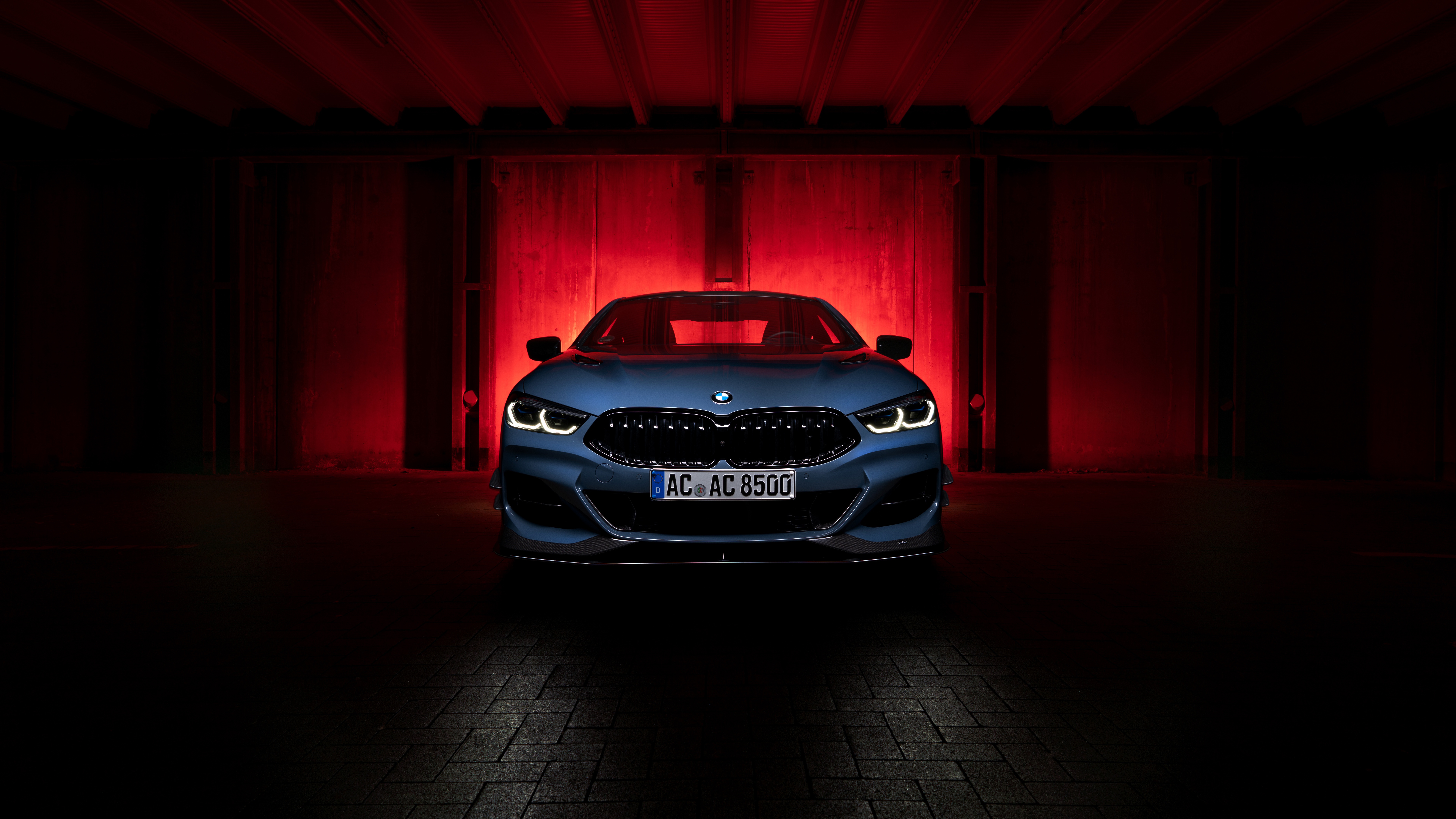 BMW 8 Series Coupe in a dark garage with red lighting HD Wallpaper