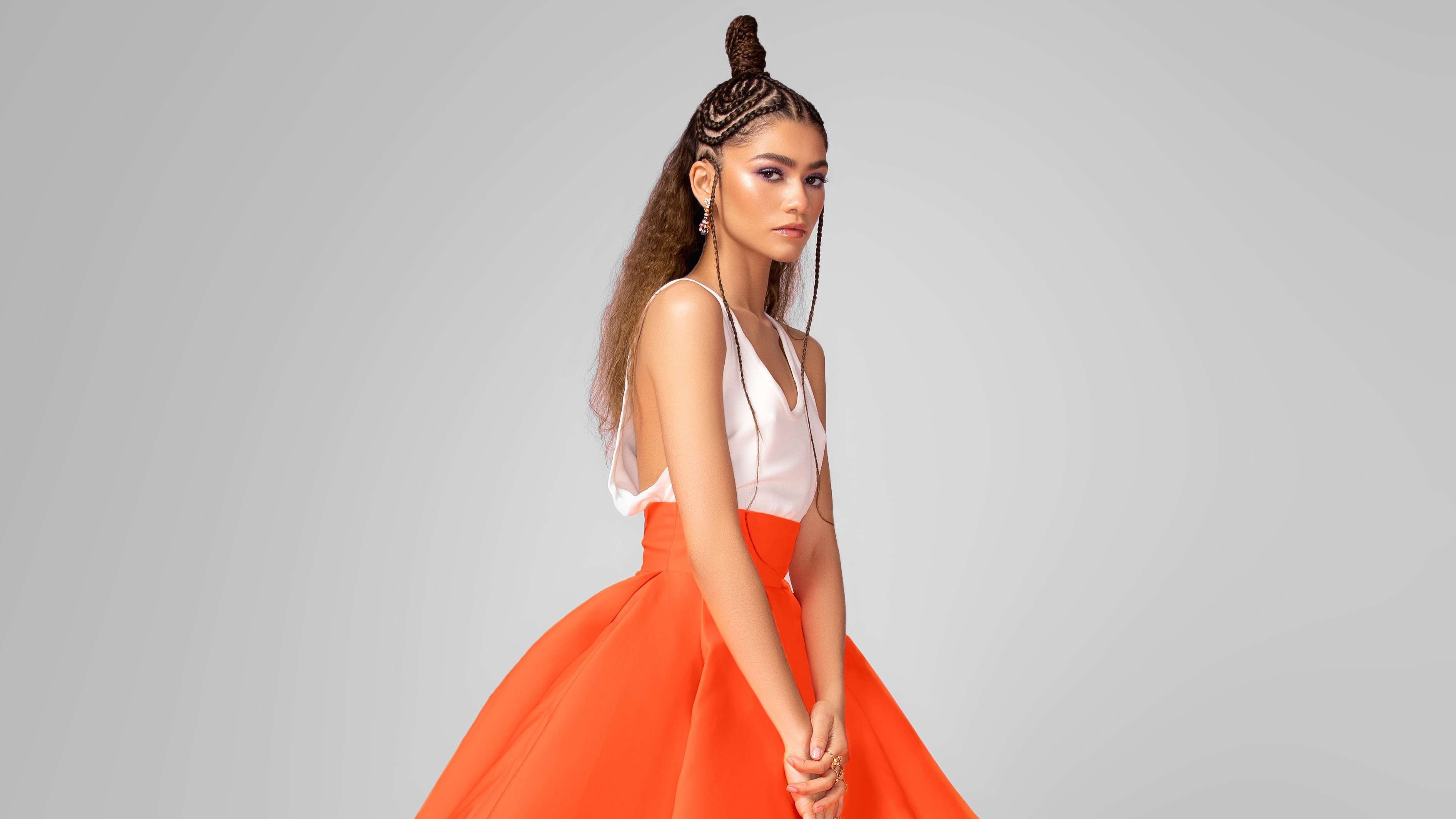 Zendaya in orange skirt and white top HD Wallpaper