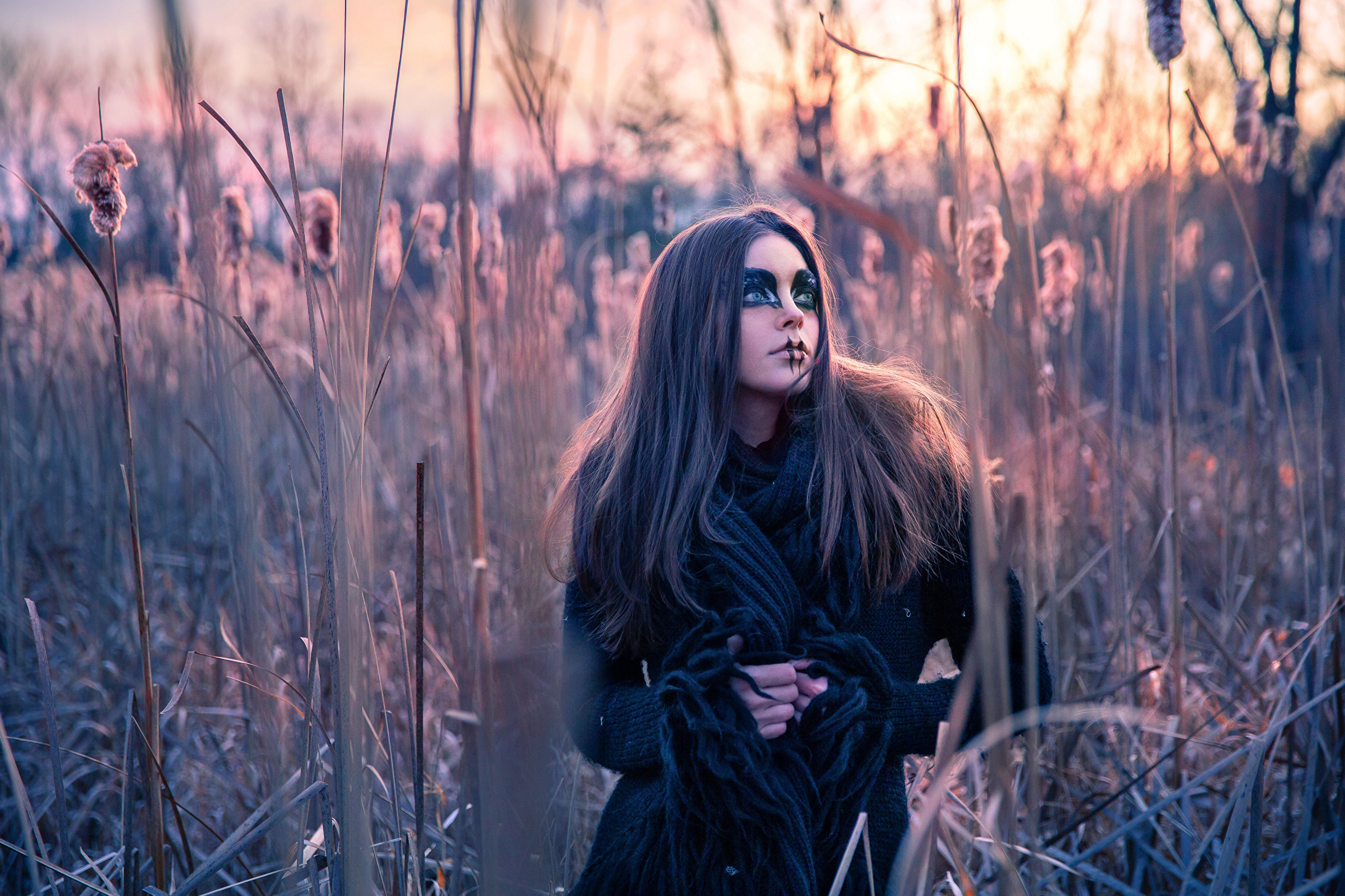 Woman with dark makeup in tall grass HD Wallpaper