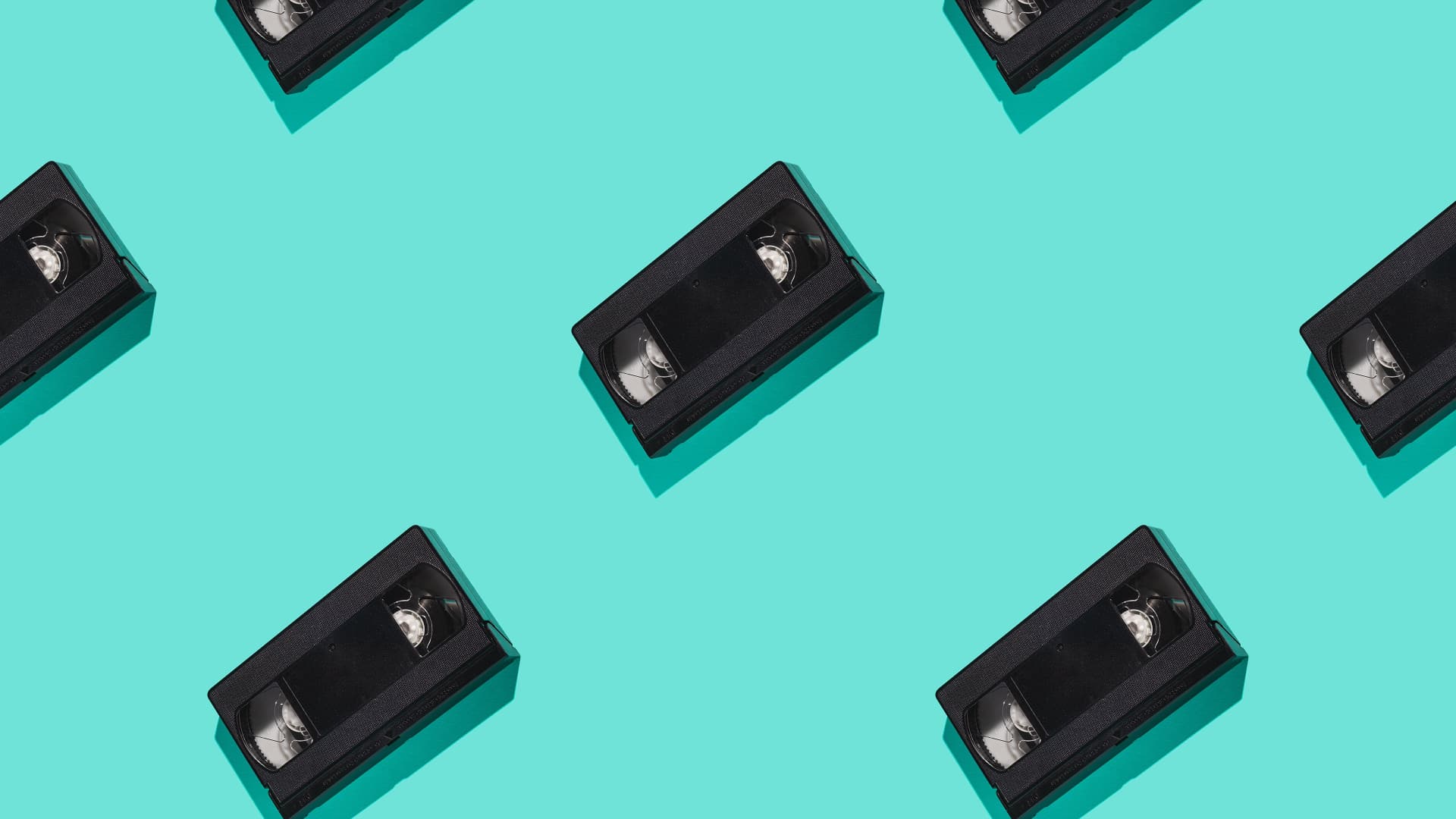 Pattern of VHS tapes on a teal background HD Wallpaper