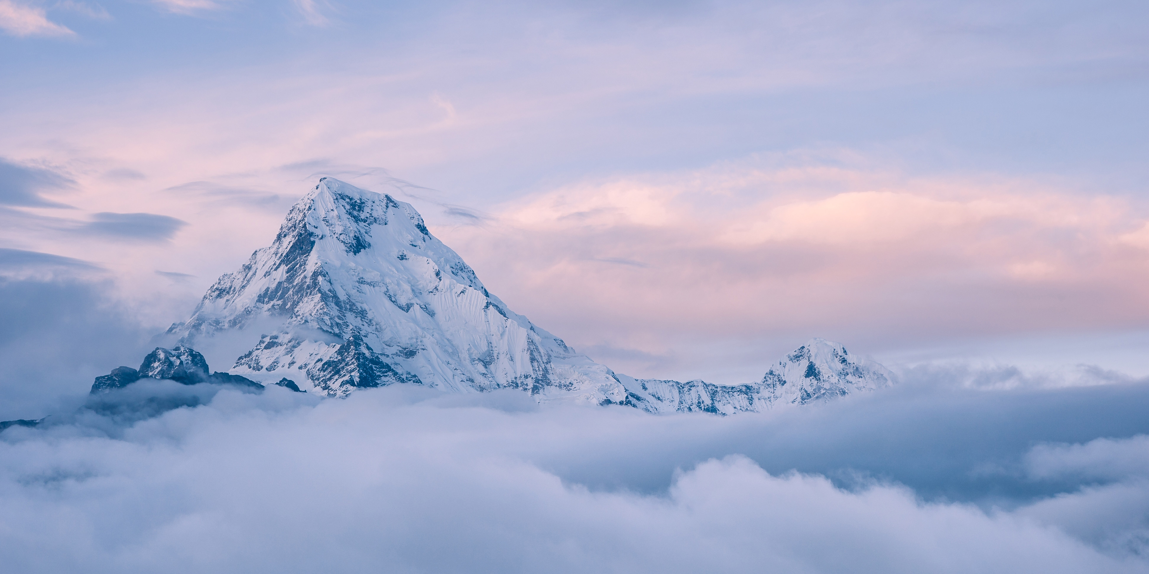 Snow-capped mountain peak above clouds at sunrise HD Wallpaper
