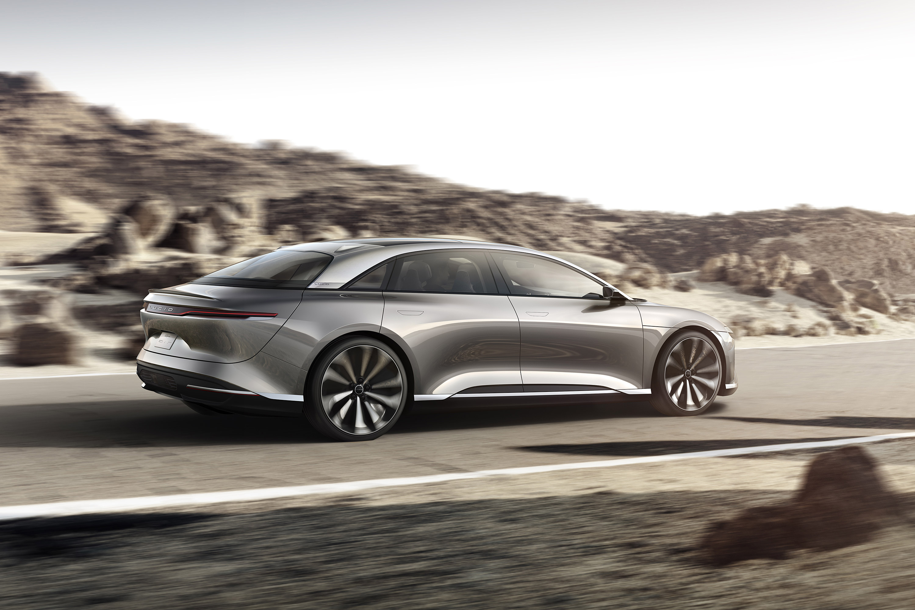 Silver Lucid Air Concept car driving on a road HD Wallpaper