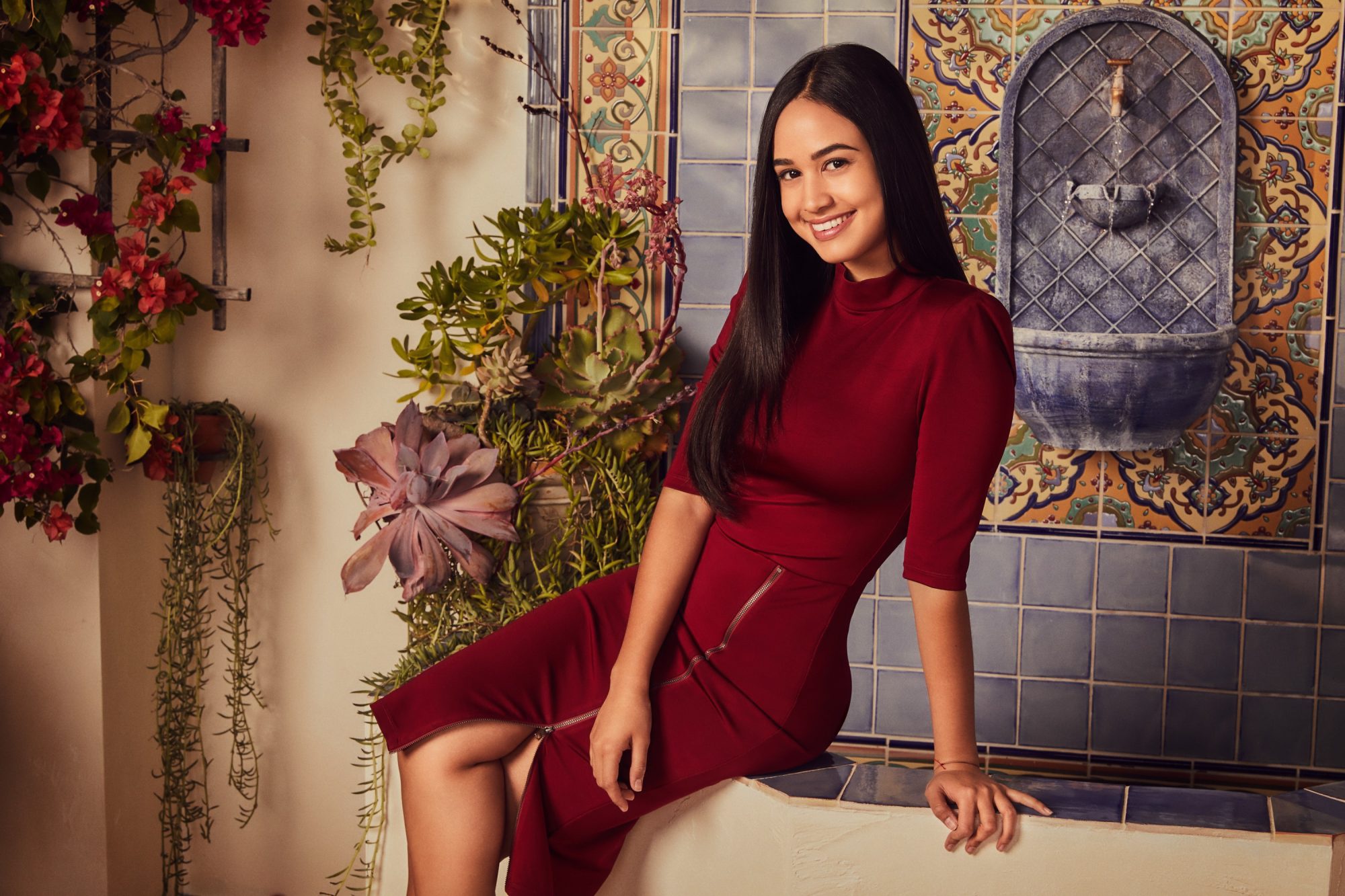 Woman in red dress with black hair smiling HD Wallpaper