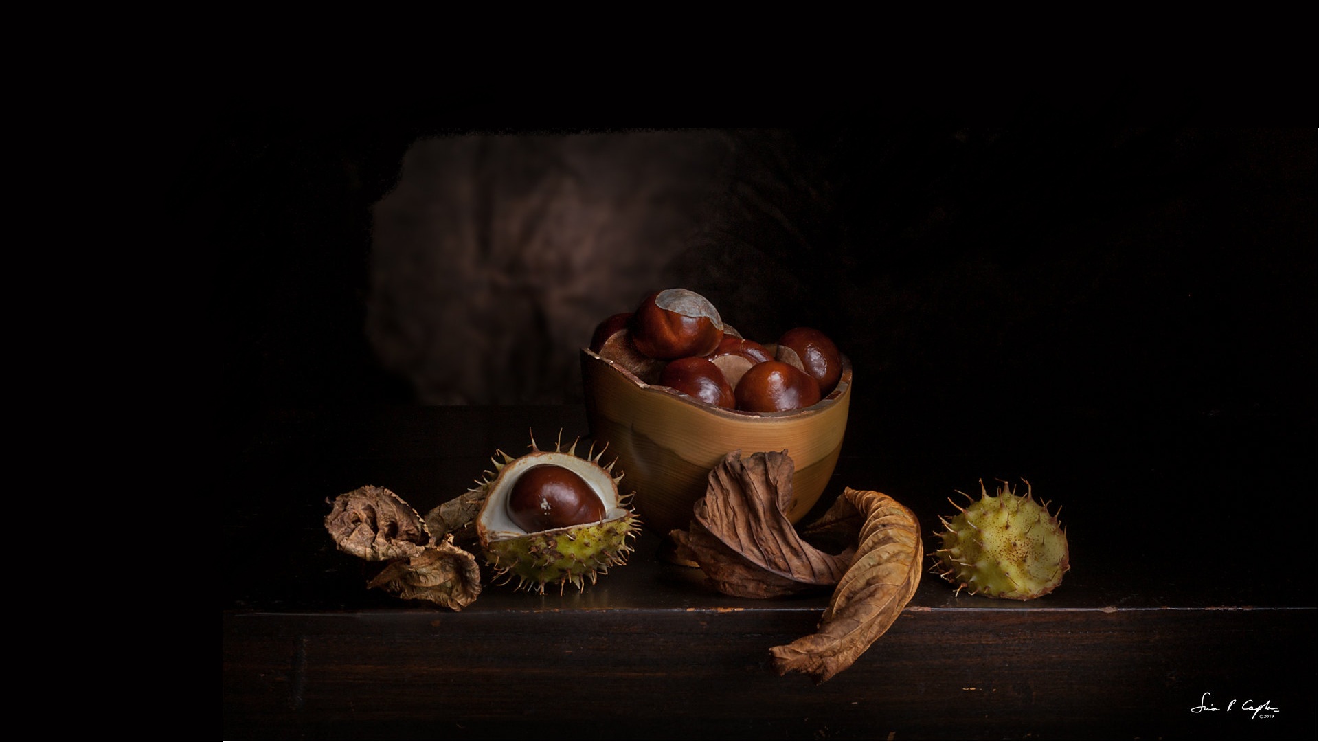 Still life of chestnuts in a bowl and on a table HD Wallpaper