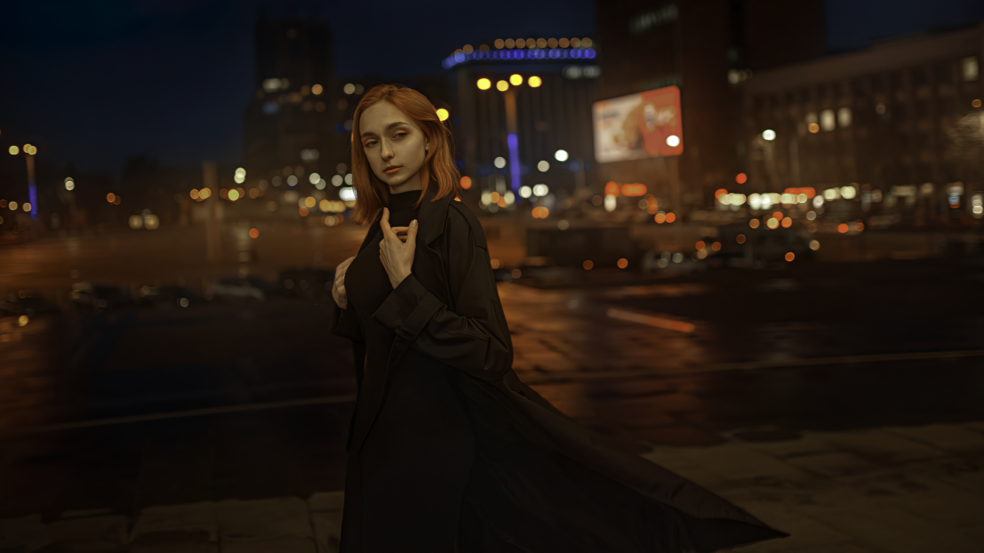 Woman with red hair in a black coat at night in the city HD Wallpaper