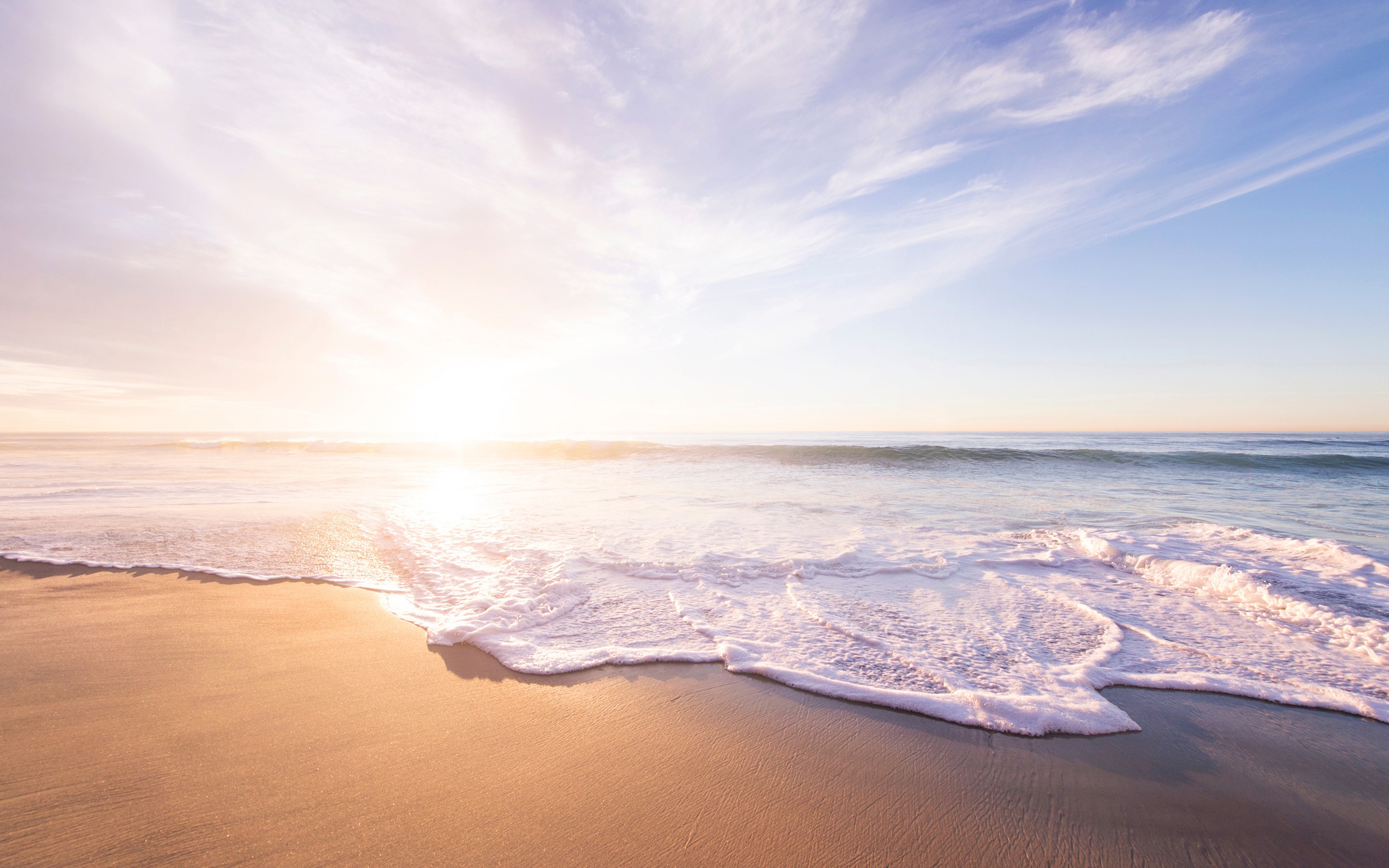 Ocean waves on a sandy beach at sunset HD Wallpaper
