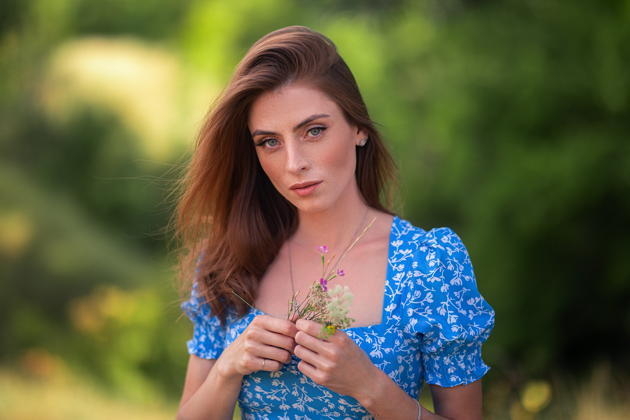 Woman with red hair and blue eyes holding flowers HD Wallpaper