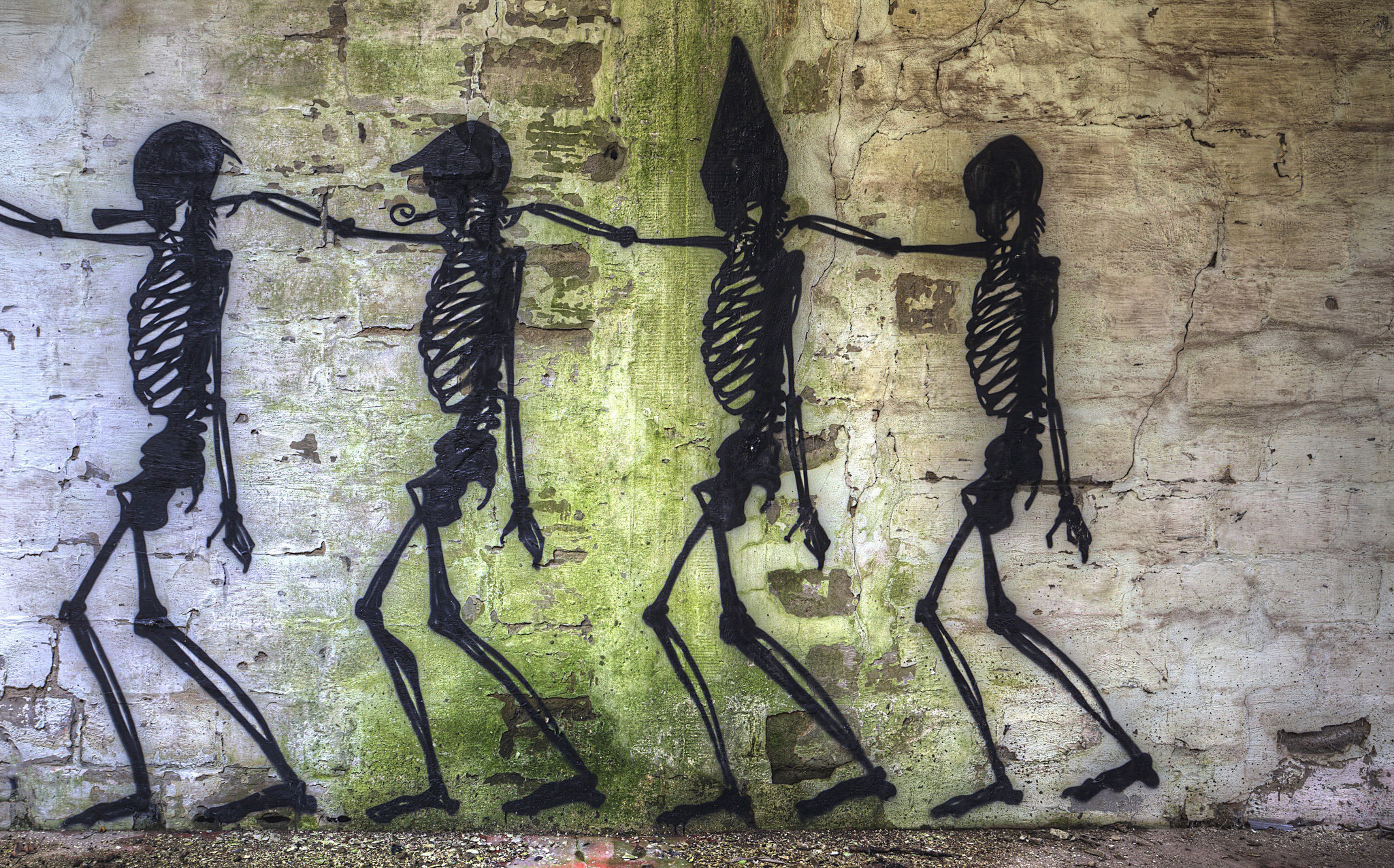 Graffiti of skeletons walking on a brick wall HD Wallpaper