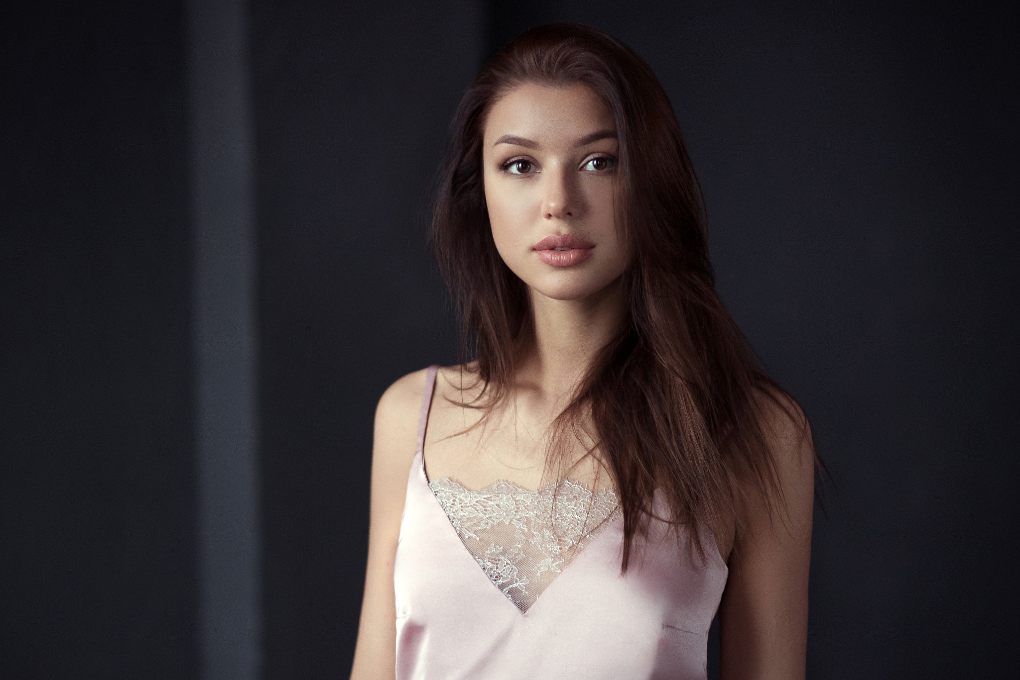 Brunette woman with brown eyes wearing a pink camisole HD Wallpaper