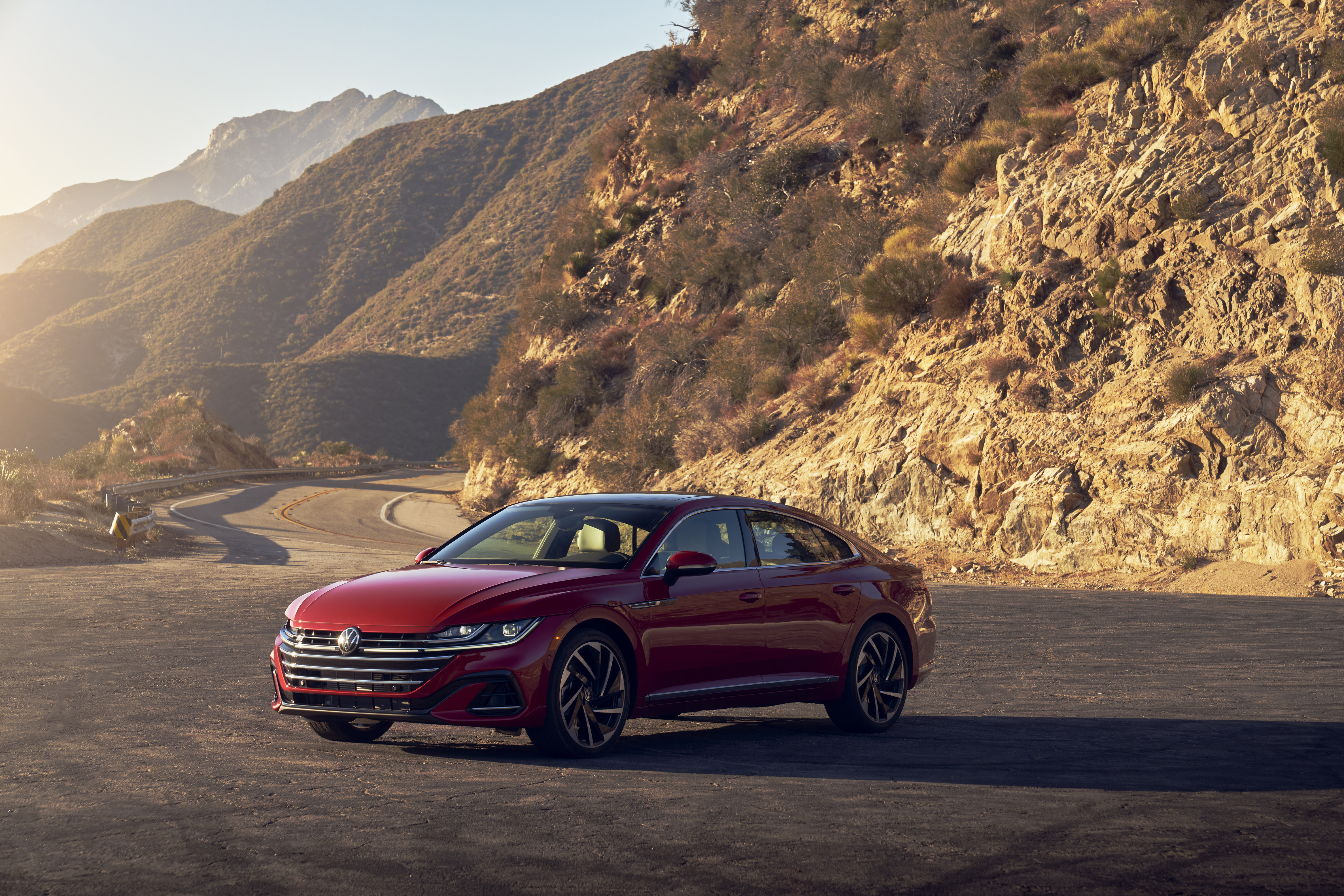 Red Volkswagen Arteon on a Mountain Road HD Wallpaper