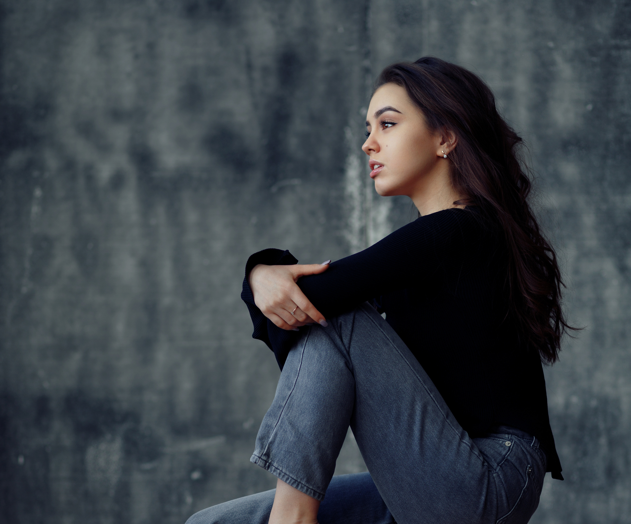 Woman with long dark hair sitting HD Wallpaper