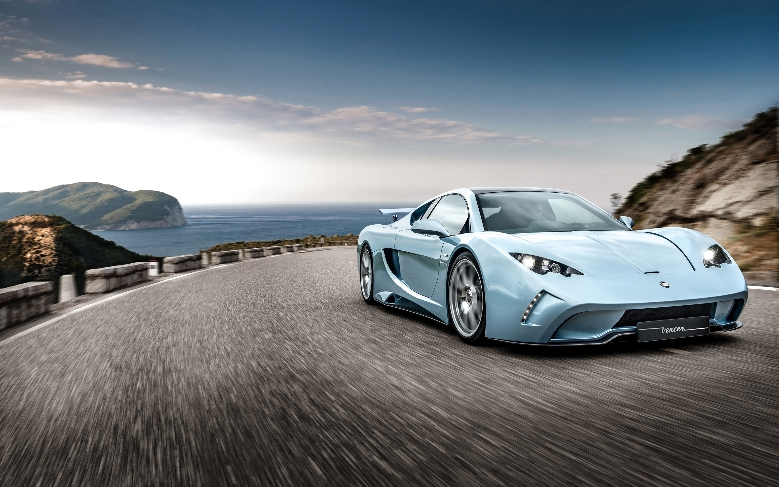 Vencer Sarthe sports car driving on a coastal road HD Wallpaper