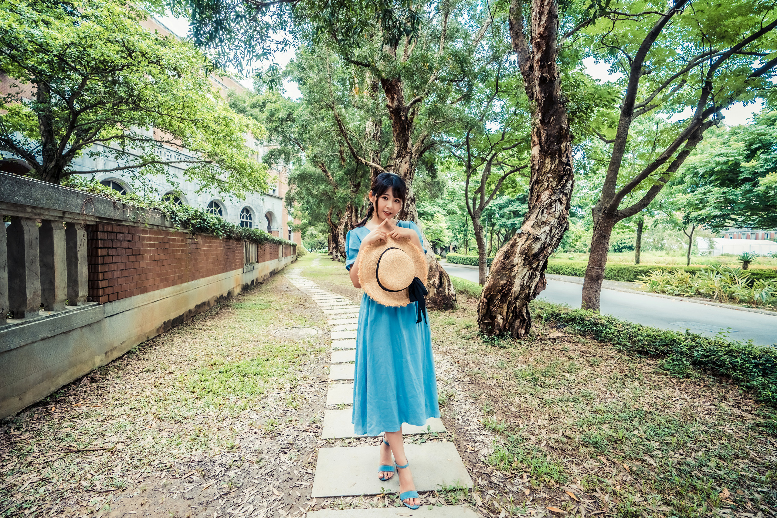Woman in blue dress holding a straw hat HD Wallpaper