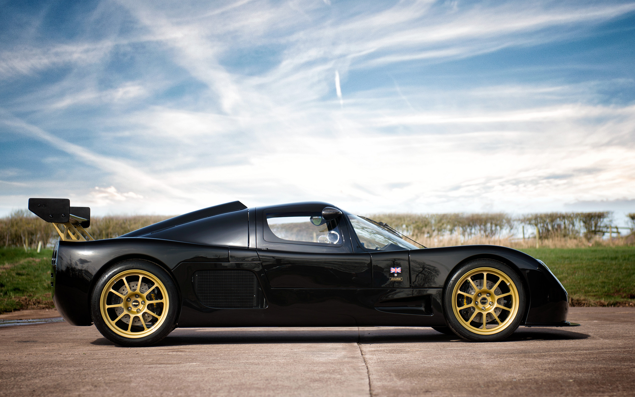 Black Ultima Evolution Coupe with gold wheels HD Wallpaper