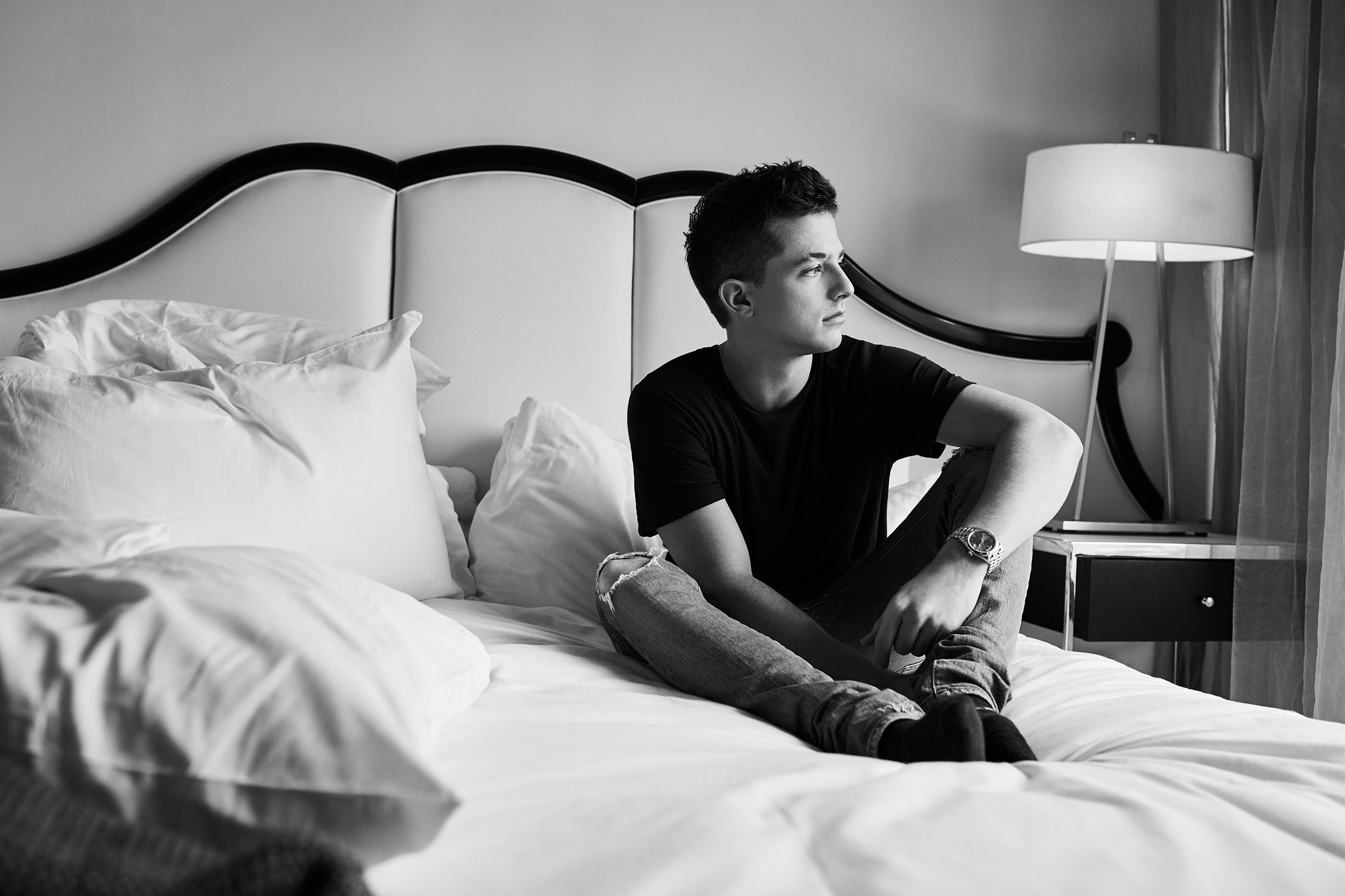Charlie Puth sitting on a bed HD Wallpaper