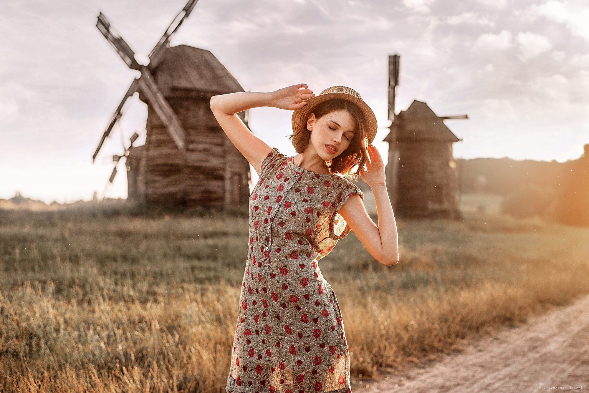 Woman in a floral dress and hat near windmills HD Wallpaper
