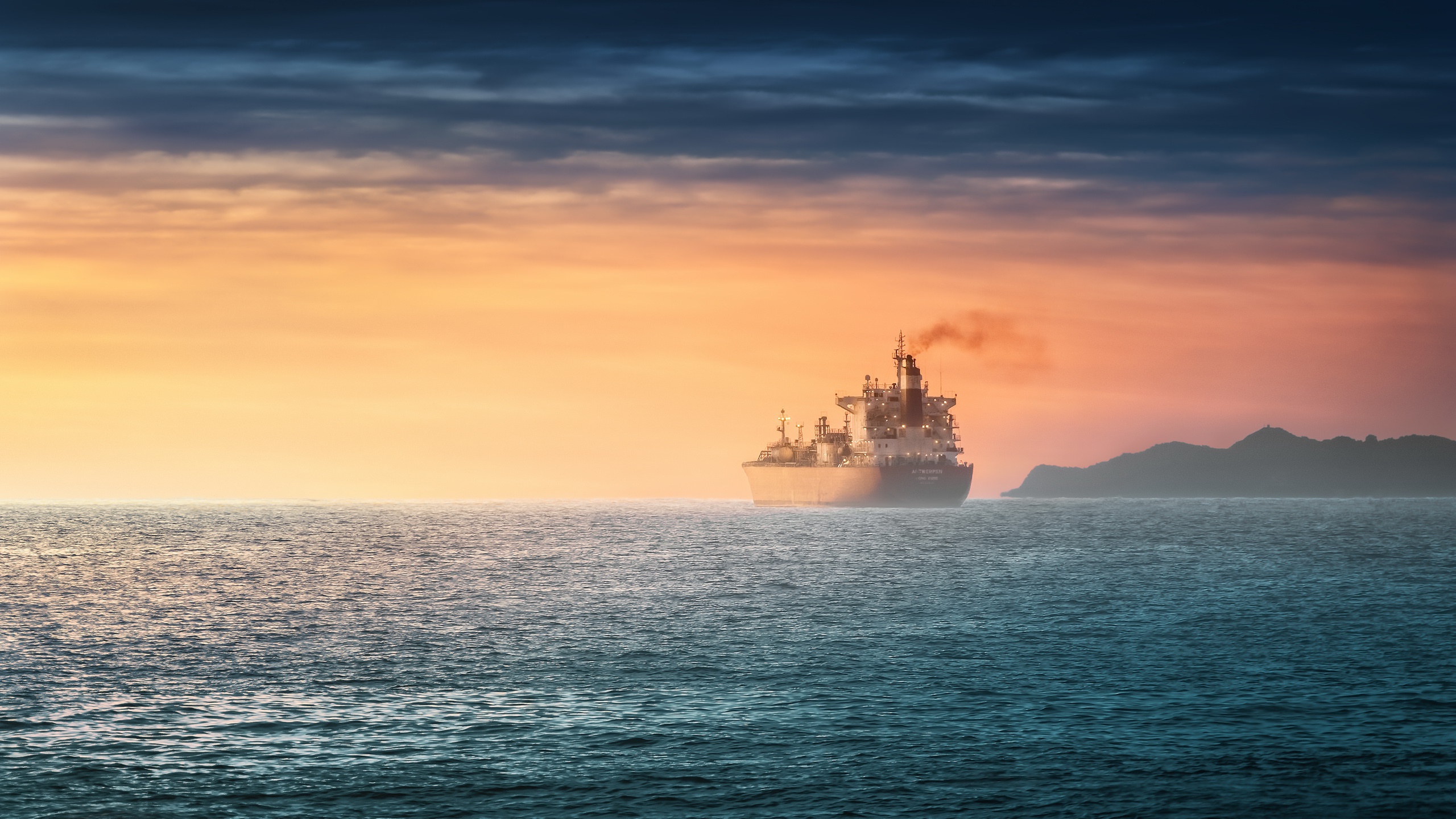 Ship sailing on the ocean at sunset HD Wallpaper