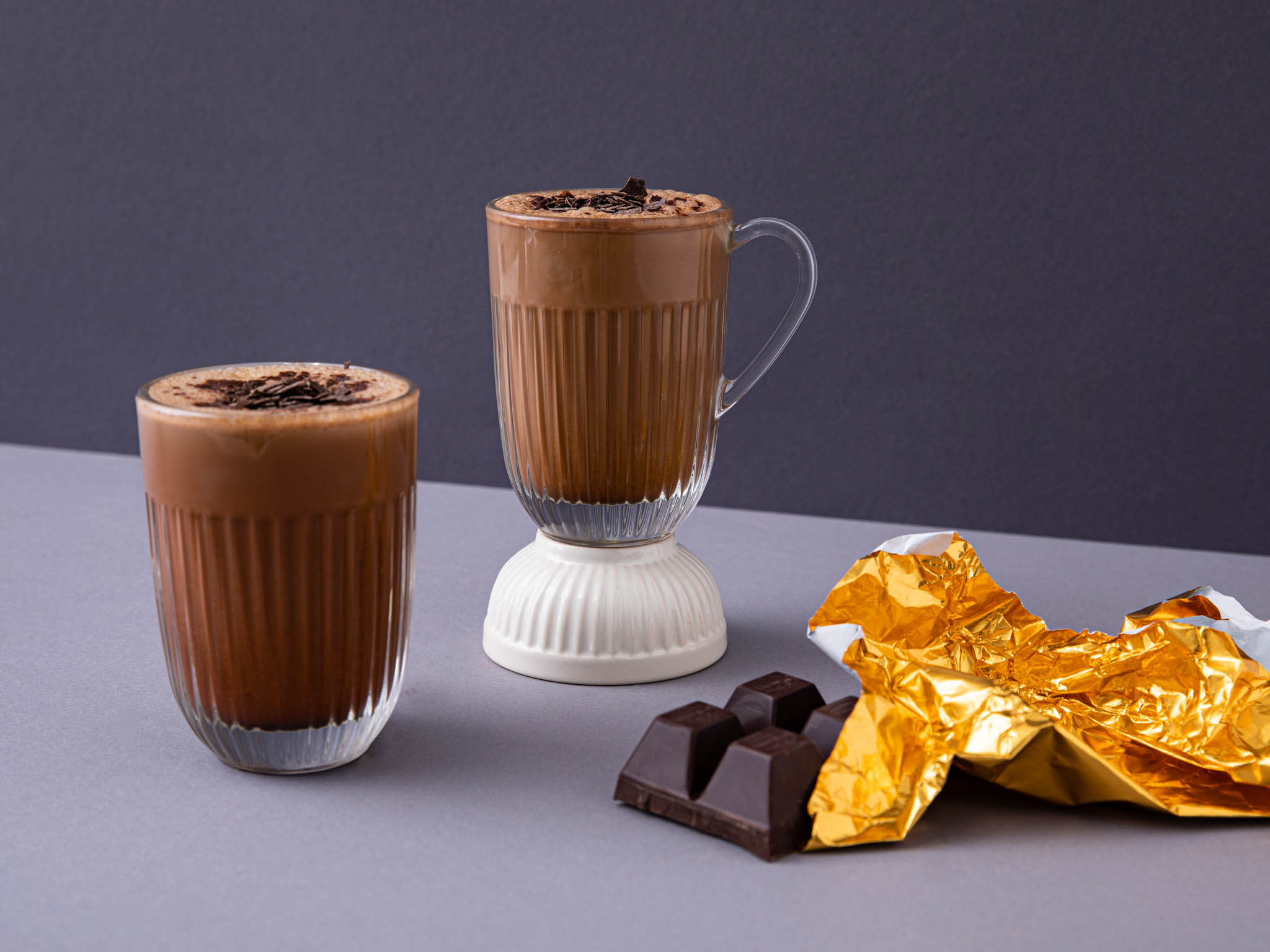 Two glasses of chocolate drink with chocolate bar and foil HD Wallpaper