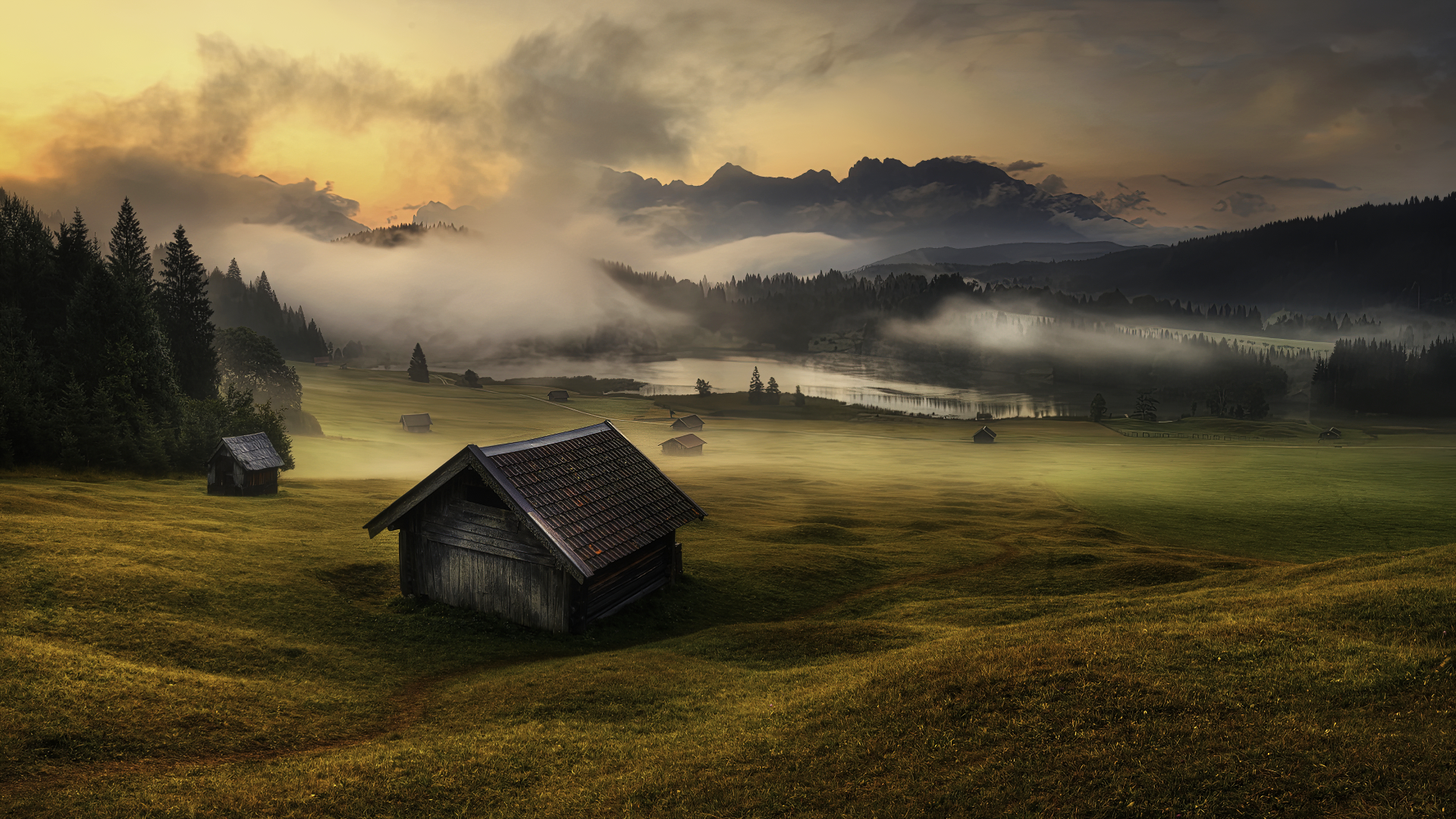 Wooden cabins in a misty mountain landscape at sunrise HD Wallpaper