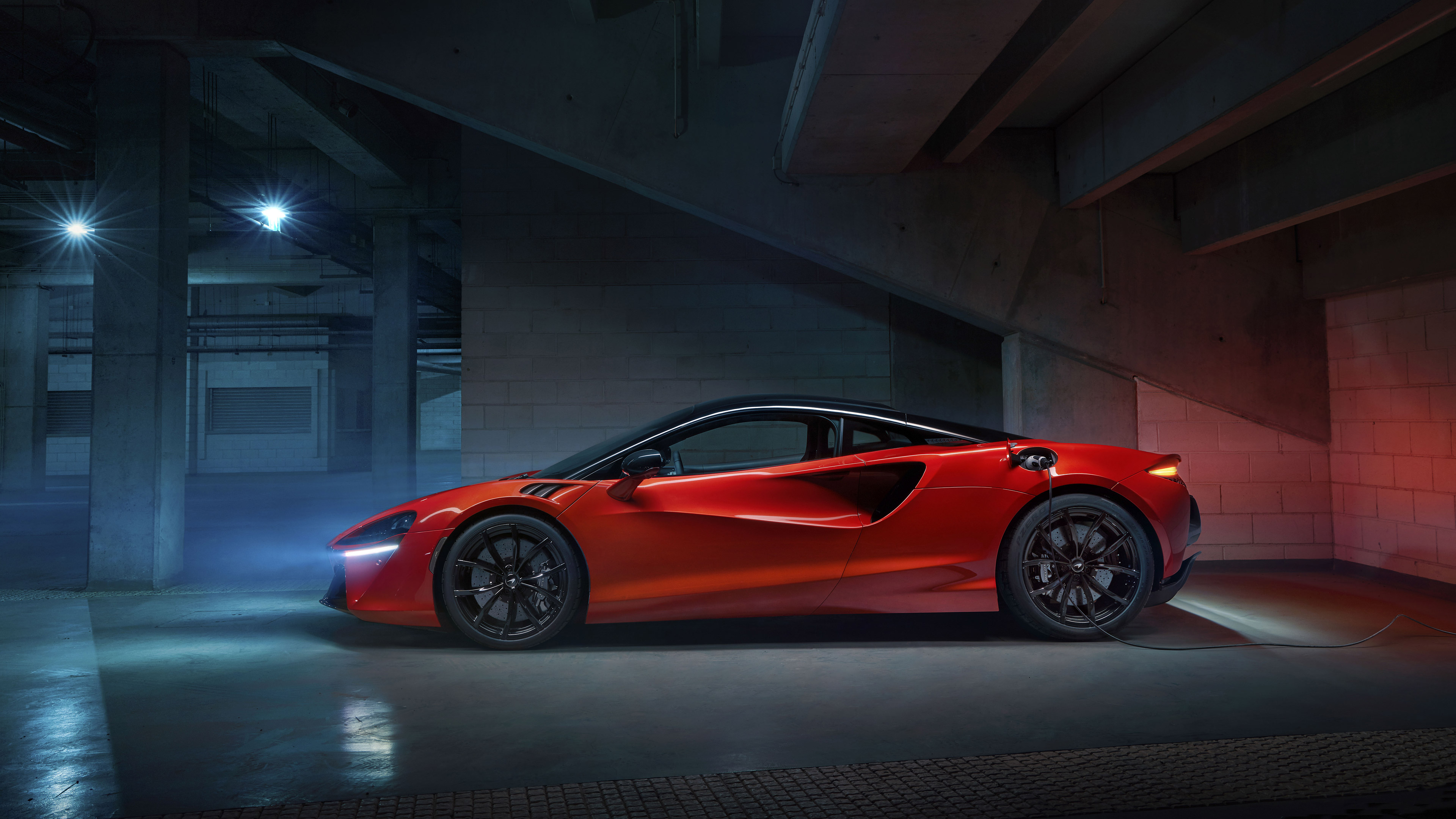 McLaren Artura charging in a dark garage HD Wallpaper