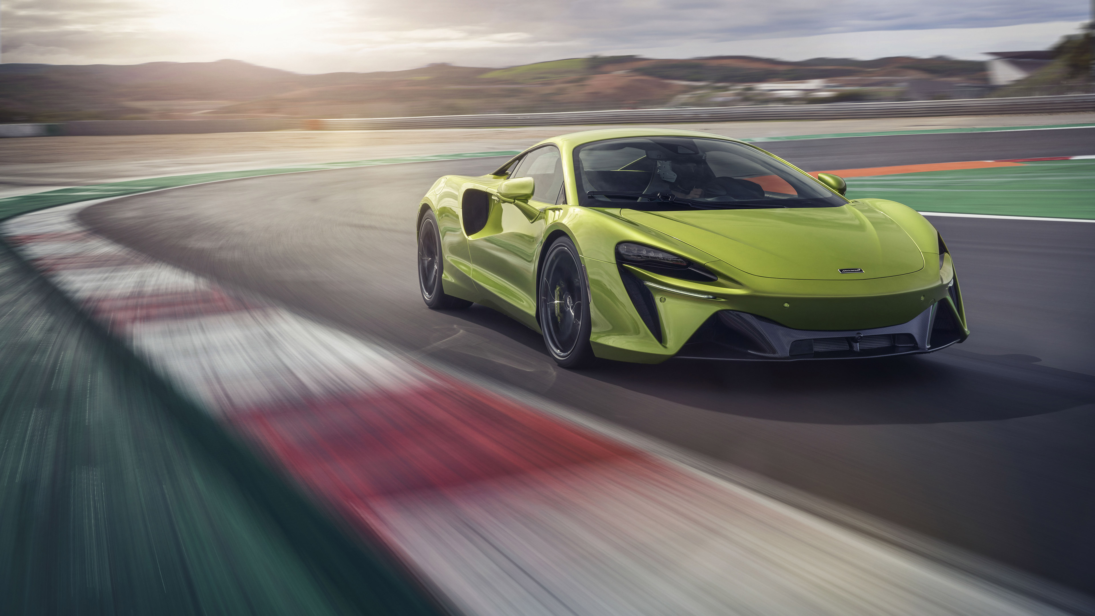 Green McLaren Artura driving on a race track HD Wallpaper