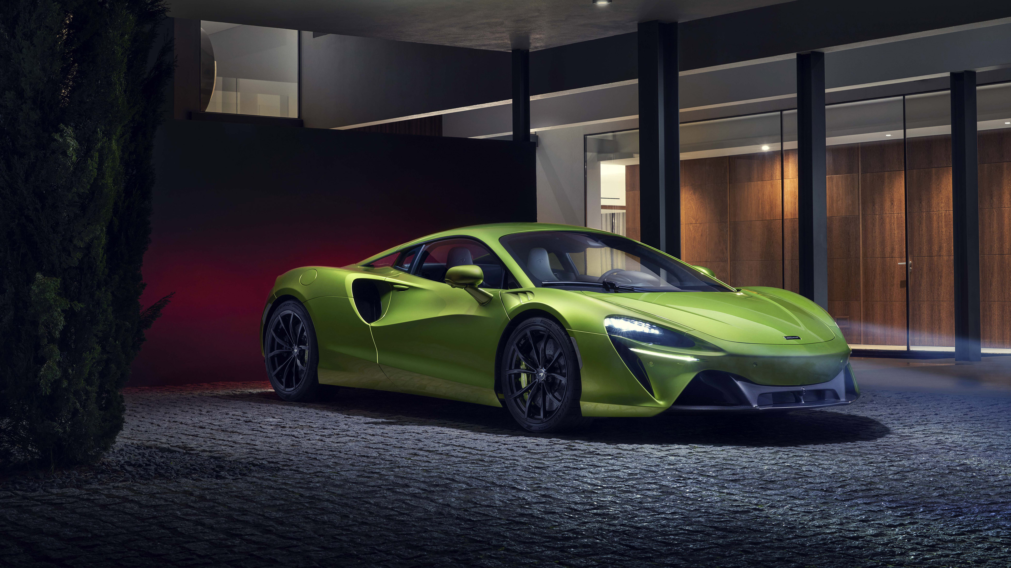 Green McLaren Artura supercar parked outside modern house HD Wallpaper