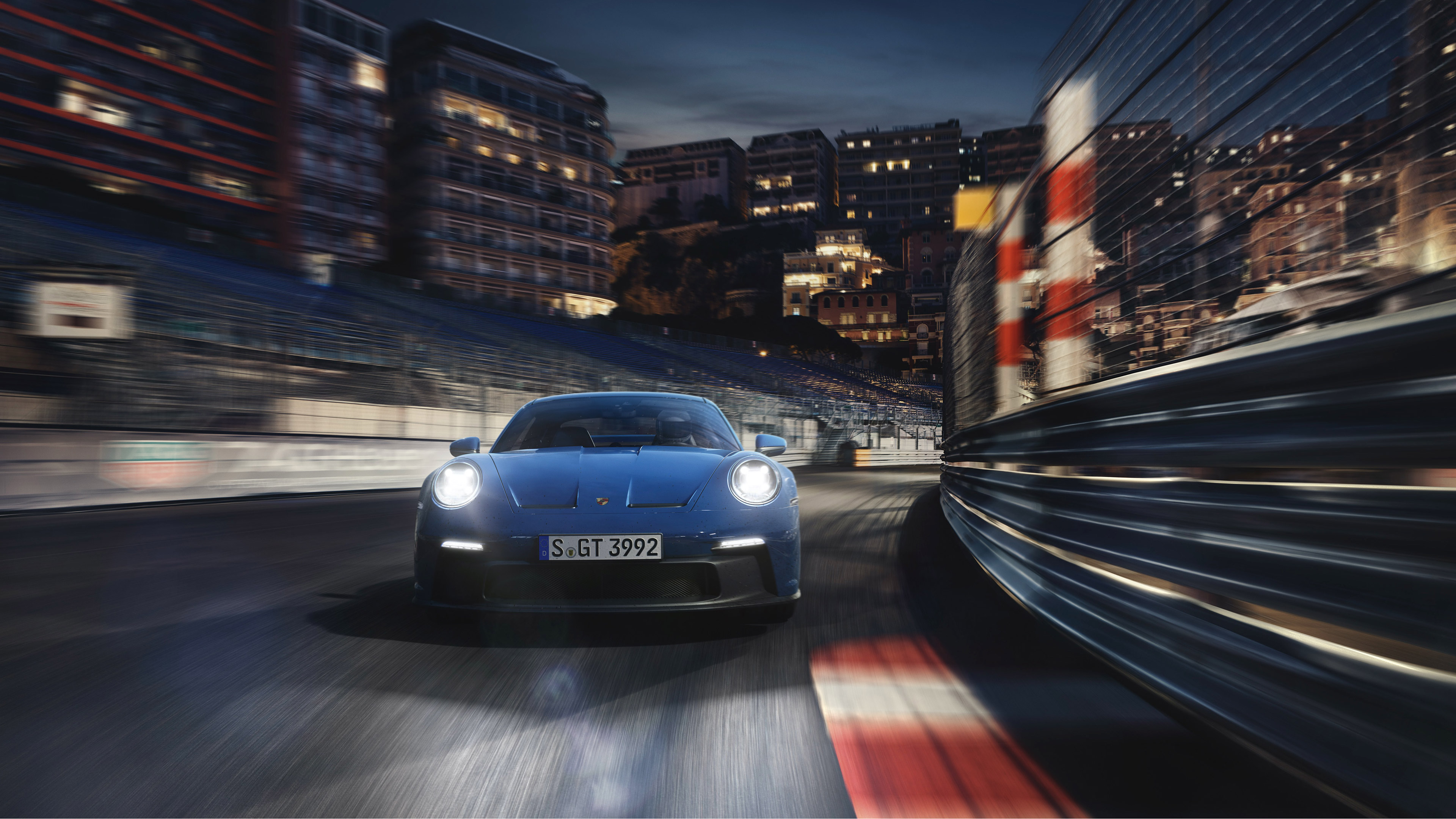 Blue Porsche 911 GT3 (992) on a race track at night HD Wallpaper