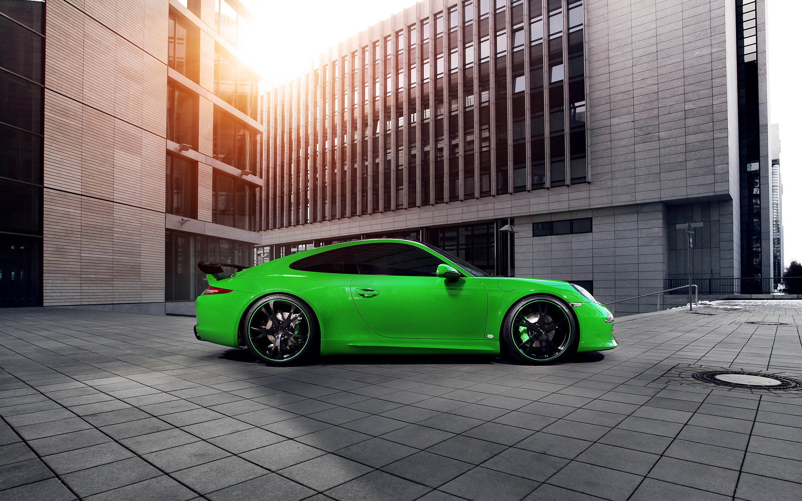 Green Porsche 911 Carrera 4S parked in front of a modern building HD Wallpaper