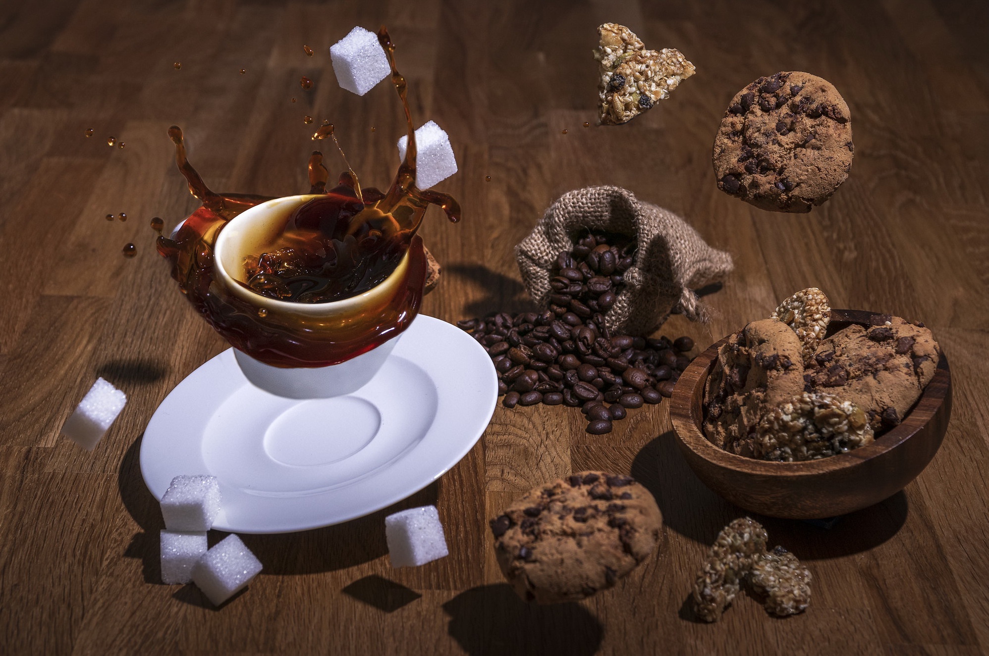 Coffee splash with sugar cubes and cookies HD Wallpaper