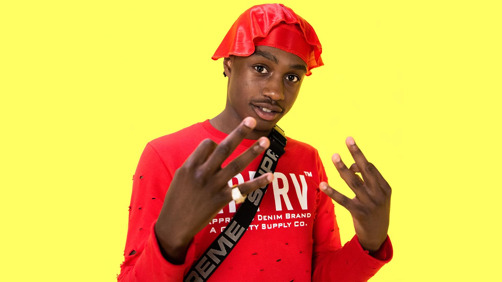 Lil Tjay wearing a red durag and shirt HD Wallpaper