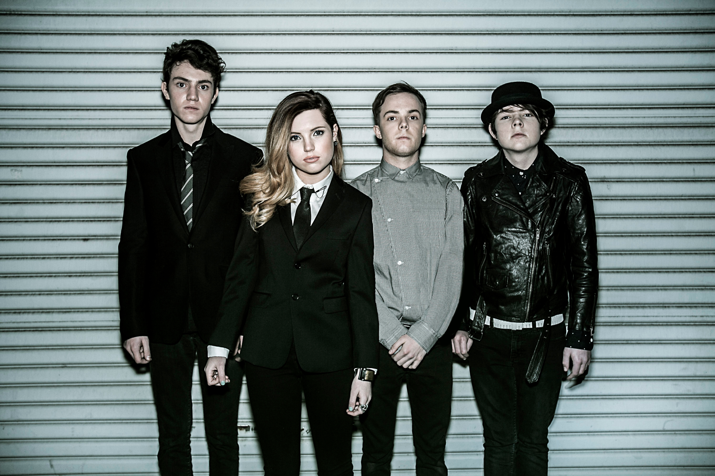 Echosmith band members posing in front of a metal wall HD Wallpaper