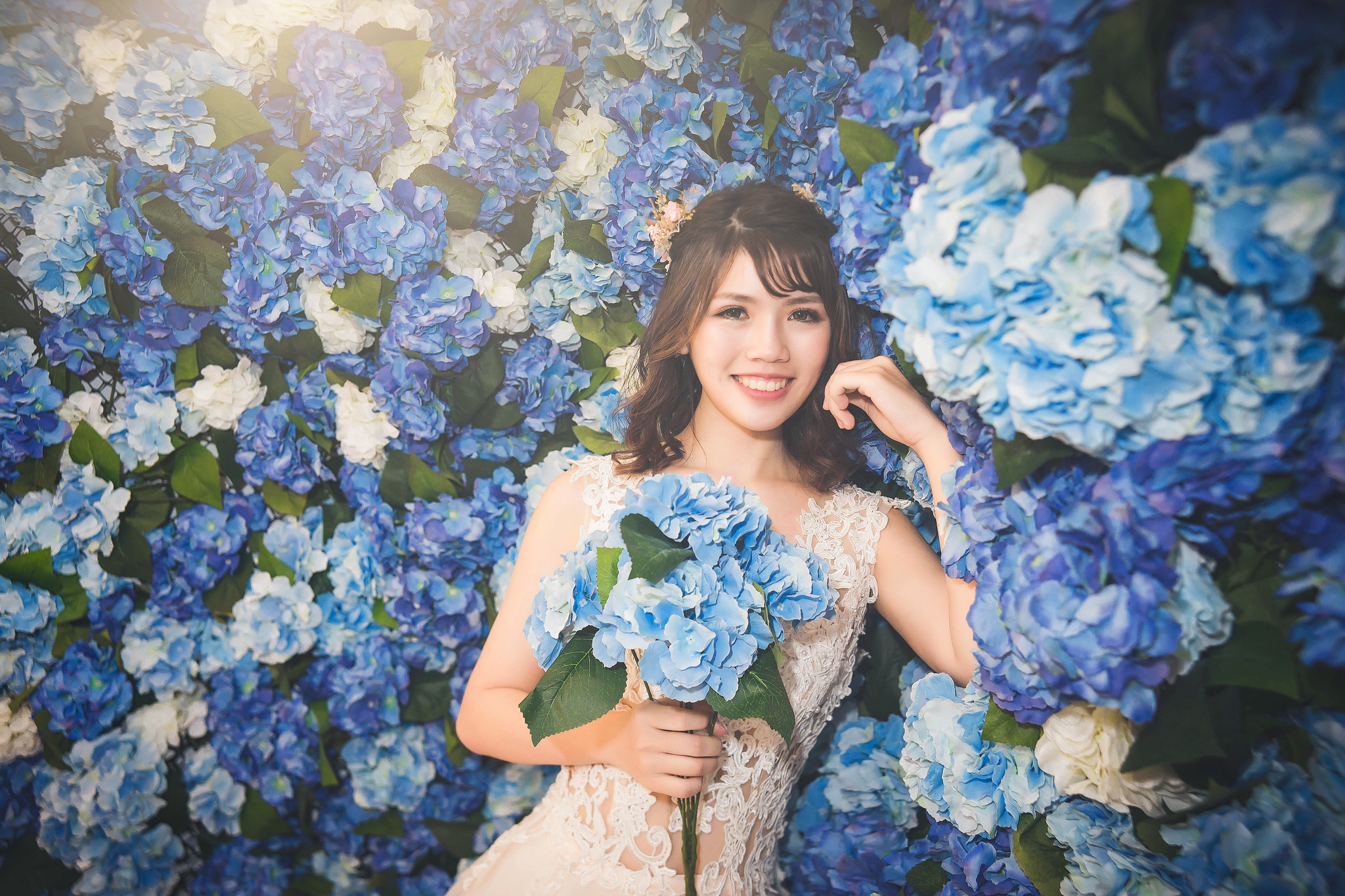 Young Asian woman in a white dress holding blue flowers HD Wallpaper