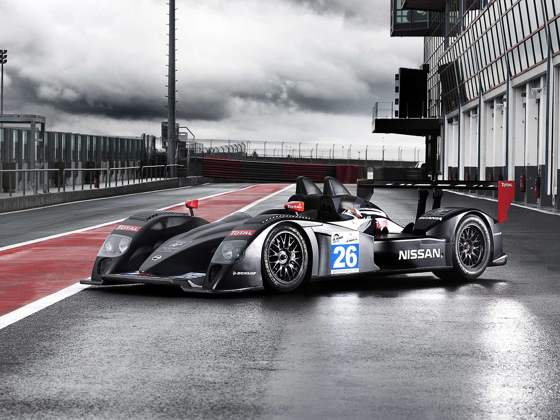 Nissan Signature Racing LMP2 car on a wet racetrack HD Wallpaper