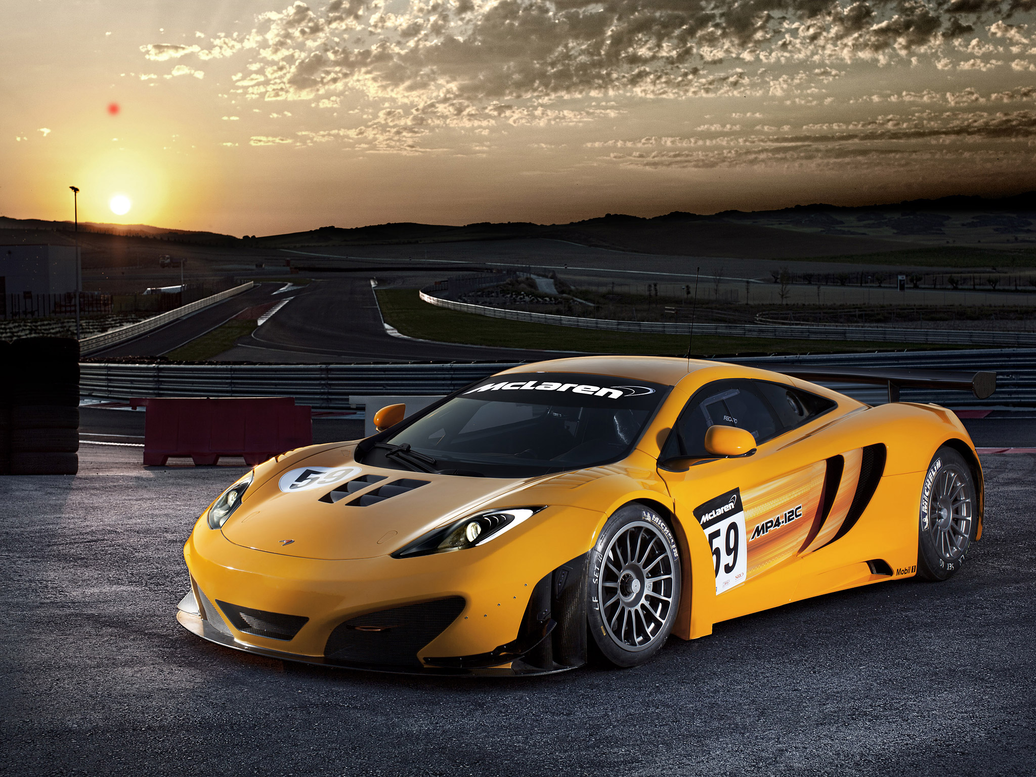 McLaren MP4-12C GT3 race car on a track HD Wallpaper