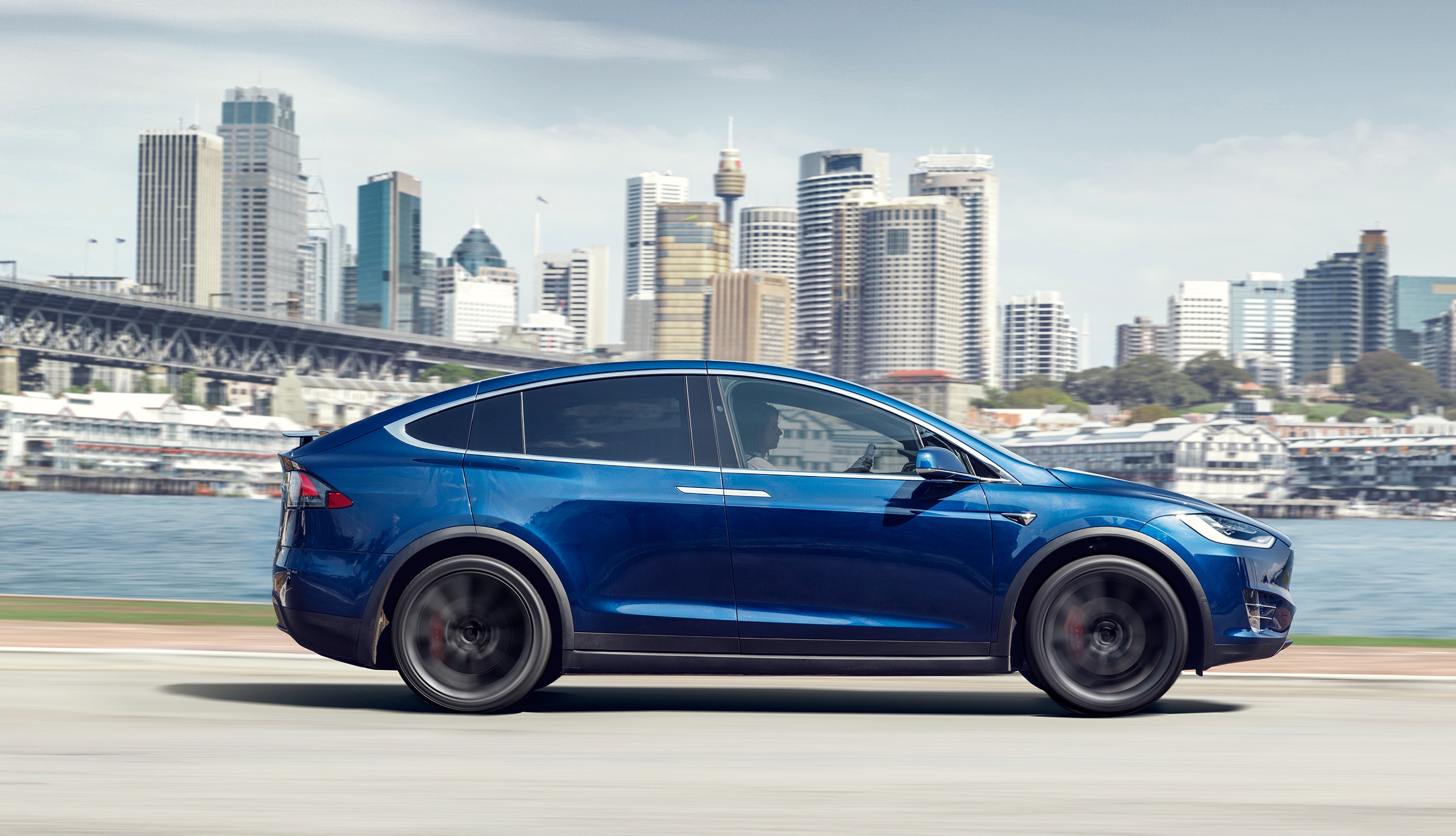Blue Tesla Model X driving in a city HD Wallpaper