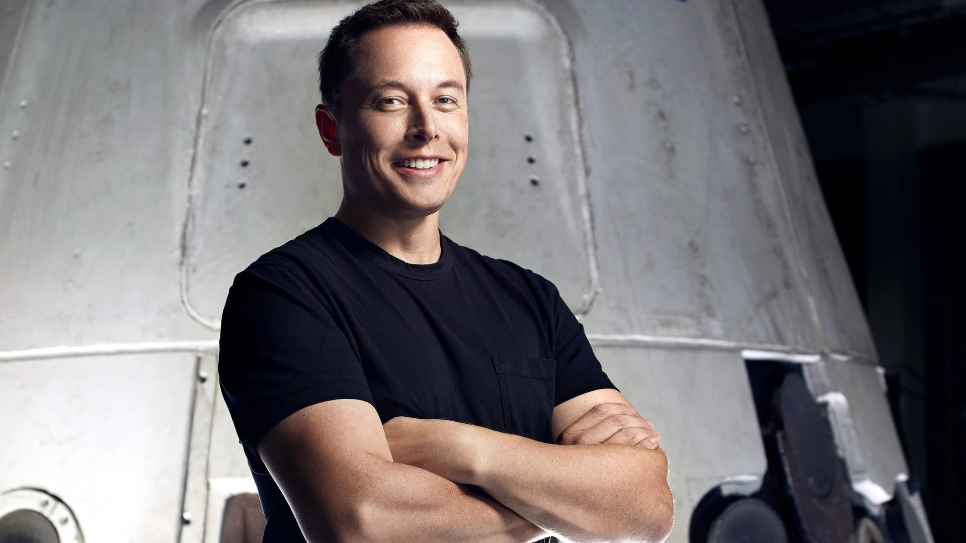 Elon Musk in front of a rocket HD Wallpaper