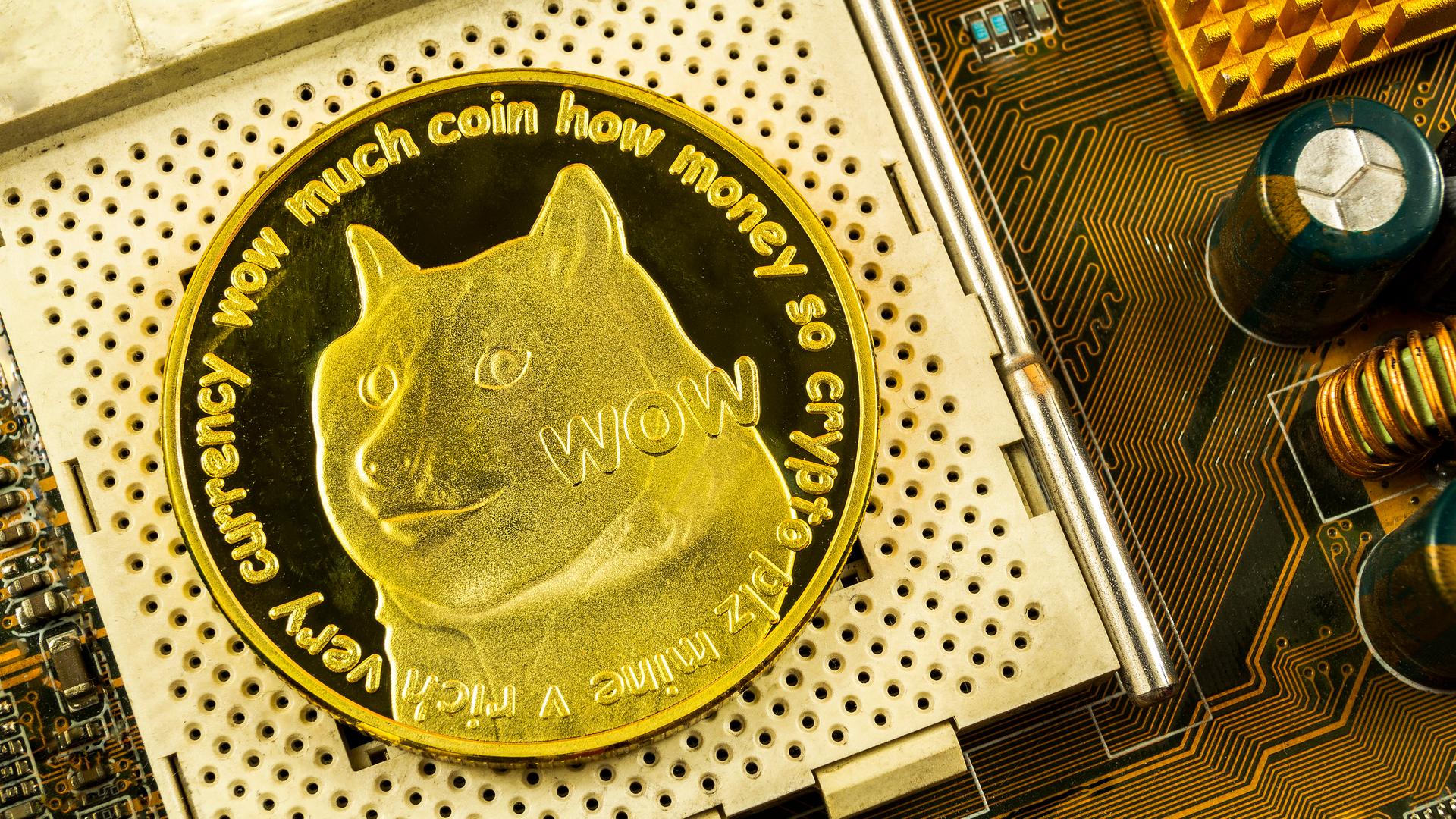 Dogecoin cryptocurrency coin on a computer motherboard HD Wallpaper
