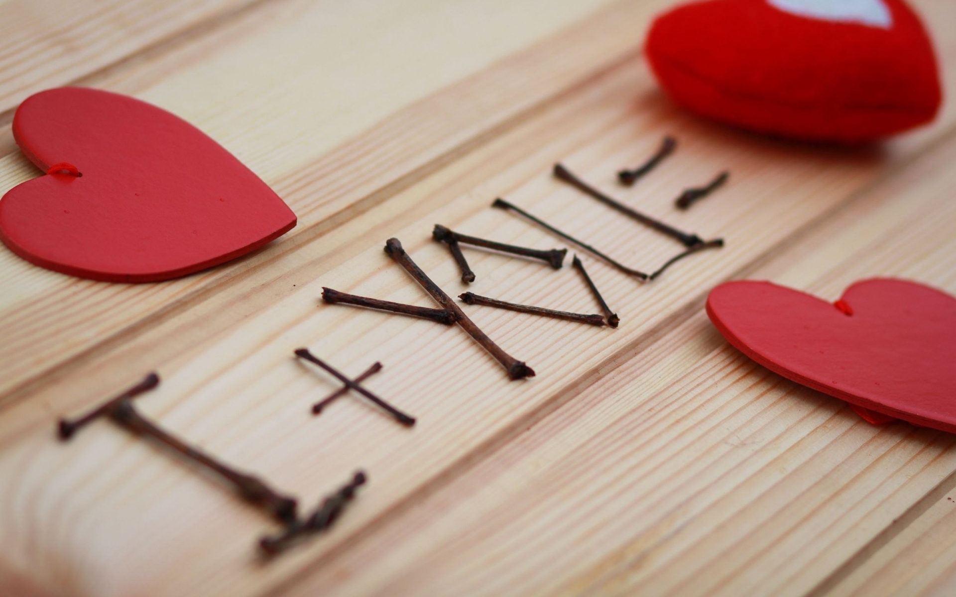 Love spelled with twigs and red hearts on wood HD Wallpaper