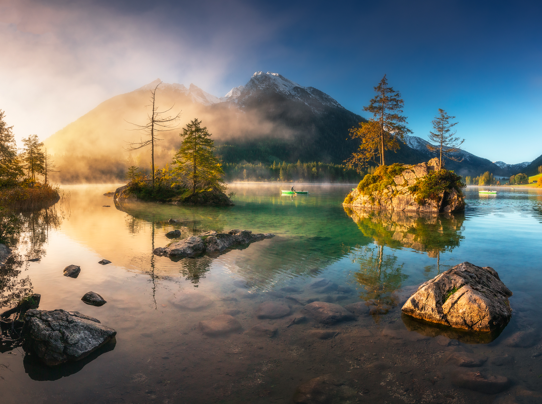 Kayaker on a misty lake with islands and mountains HD Wallpaper