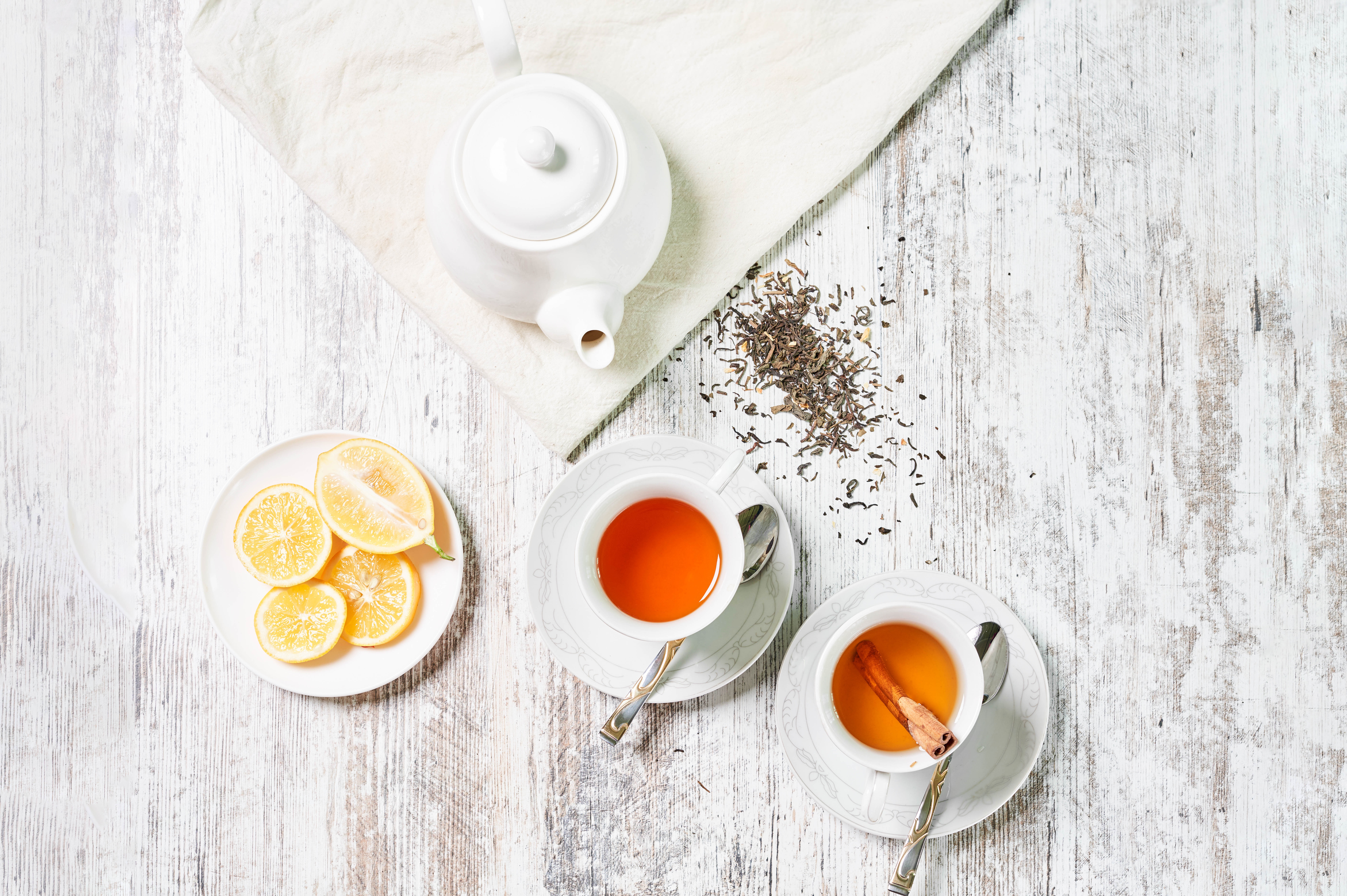 Tea set with lemon slices and cinnamon stick HD Wallpaper