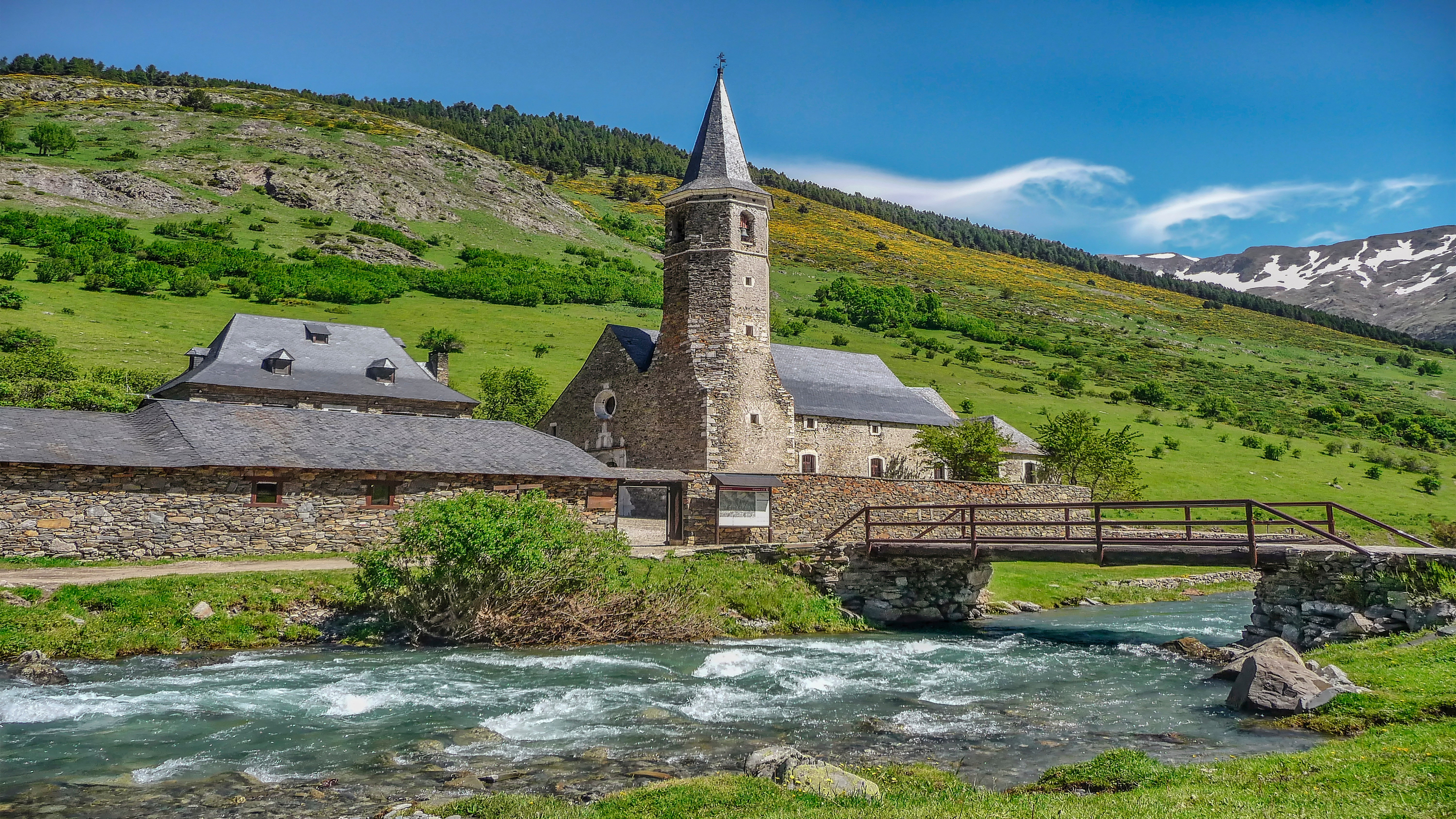 Church and bridge over a river in a mountain landscape HD Wallpaper