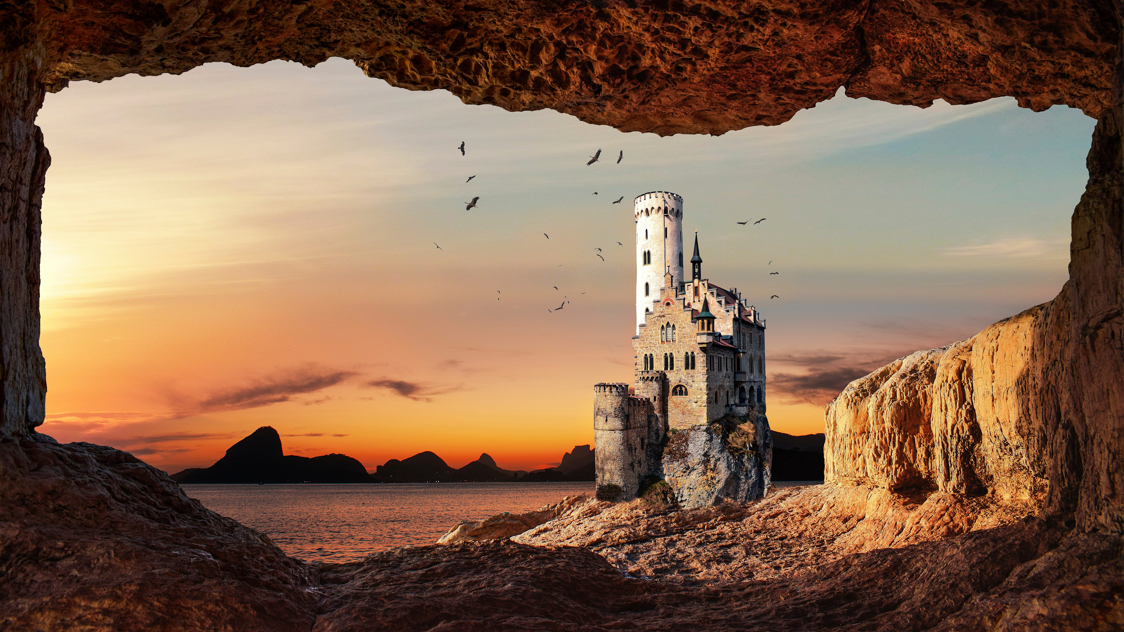 Castle on a cliff overlooking the sea at sunset viewed from a cave HD Wallpaper